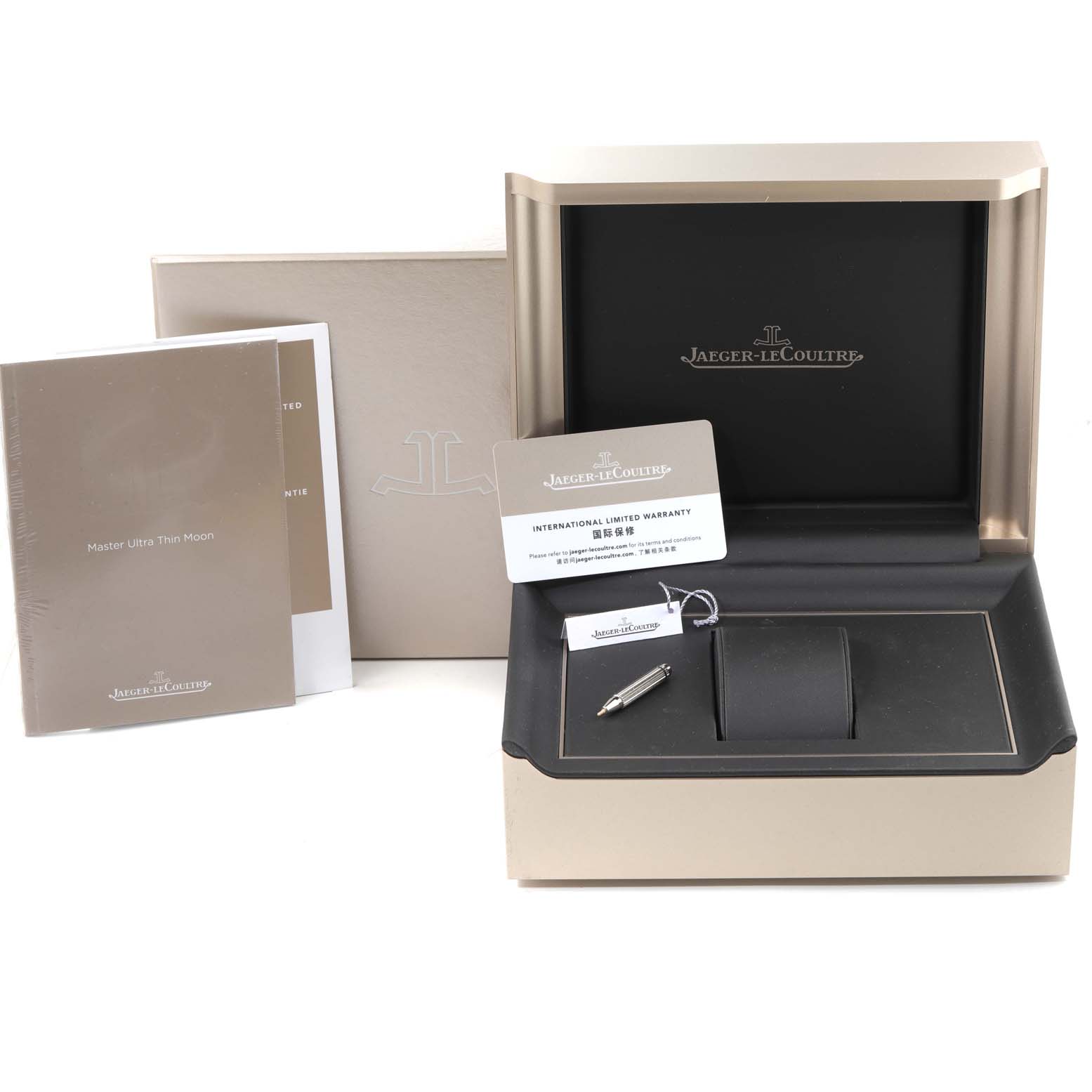 The image shows the Jaeger-LeCoultre Master model watch box, warranty card, manual, and pen from a front angle.