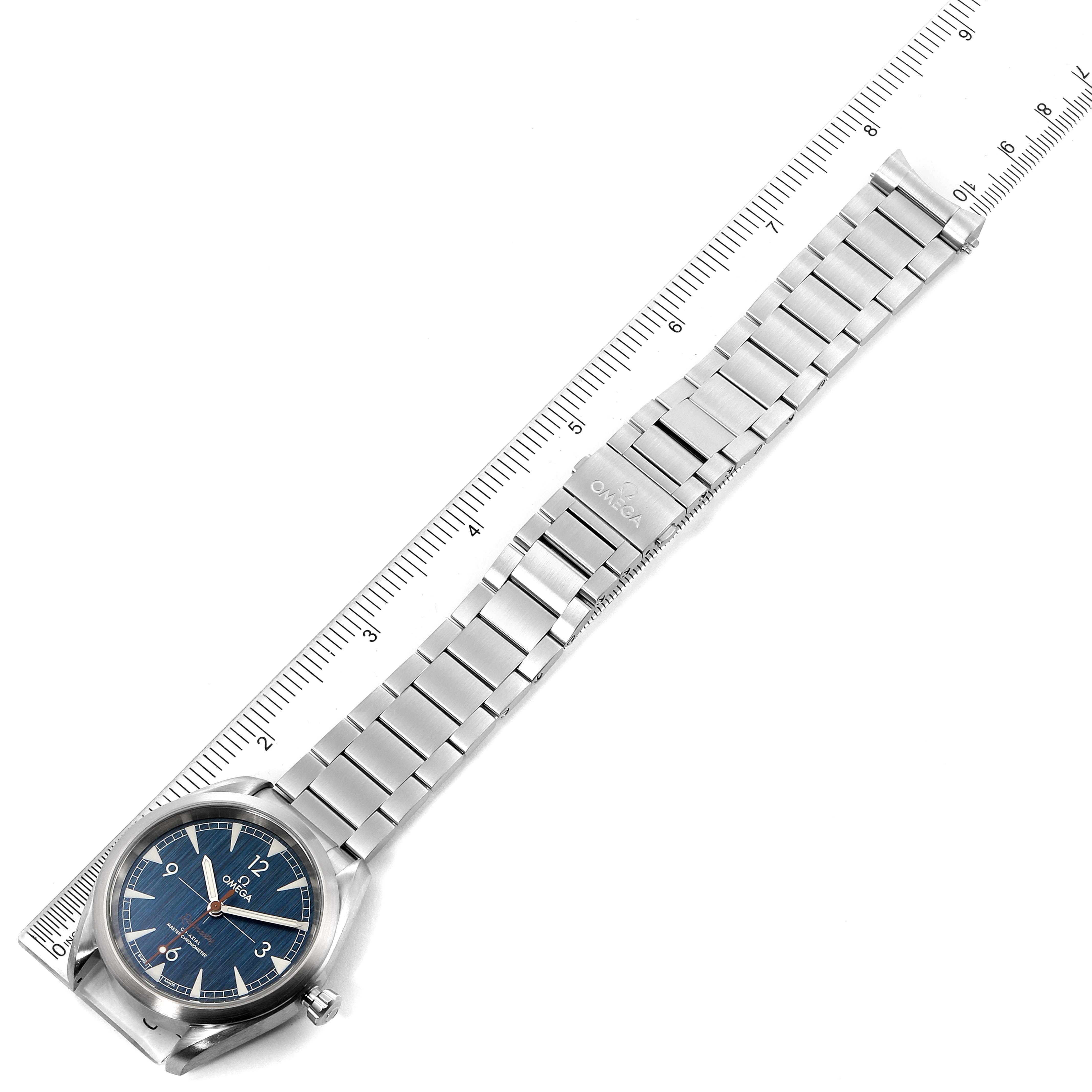 The image shows the Omega Seamaster 220.10.40.20.03.001 Men
s Stainless Steel Blue Dial 220.10.40.20.03.001 Men
s Stainless Steel Blue Dial watch at a diagonal angle, displaying its face, bezel, bracelet, and clasp, measured against a ruler.