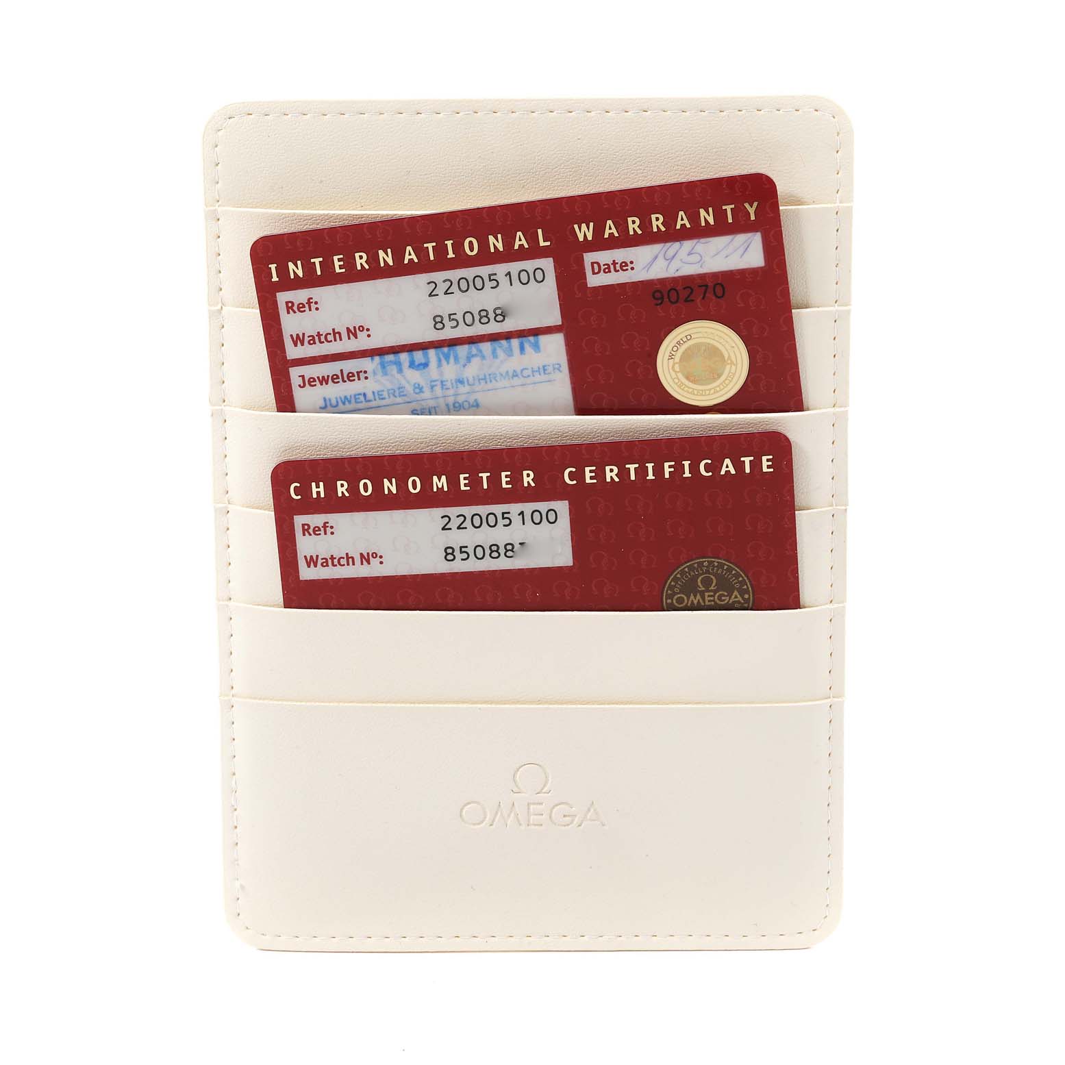 The image shows the international warranty and chronometer certificate cards for an Omega Planet Ocean 2200.51.00 Men
s Stainless Steel Black Dial 2200.51.00 Men
s Stainless Steel Black Dial watch in a white Omega cardholder.