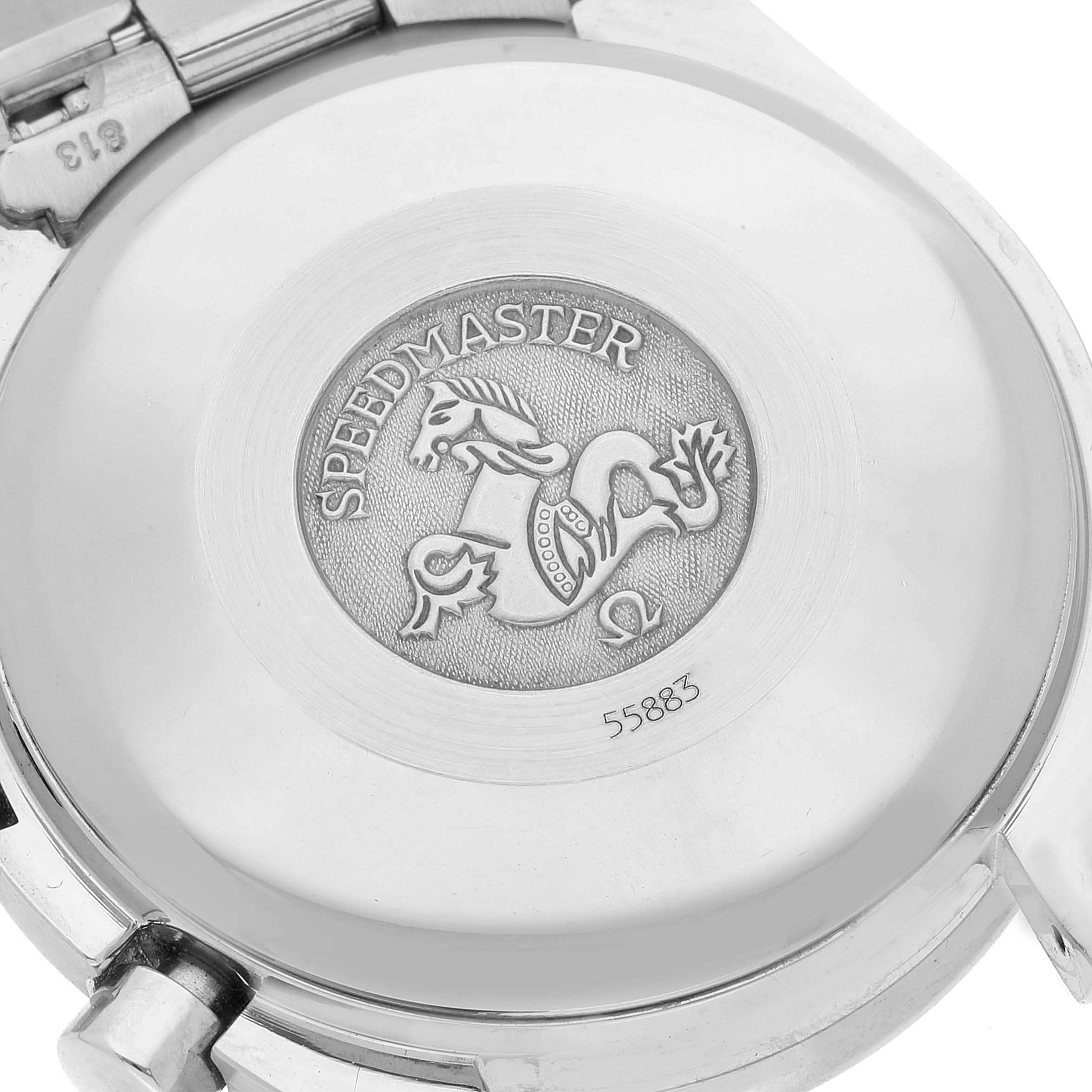 The image shows the engraved case back of an Omega Speedmaster 3521.80.00 Men's Stainless Steel Blue Dial 3521.80.00 Men's Stainless Steel Blue Dial watch viewed from a top angle.