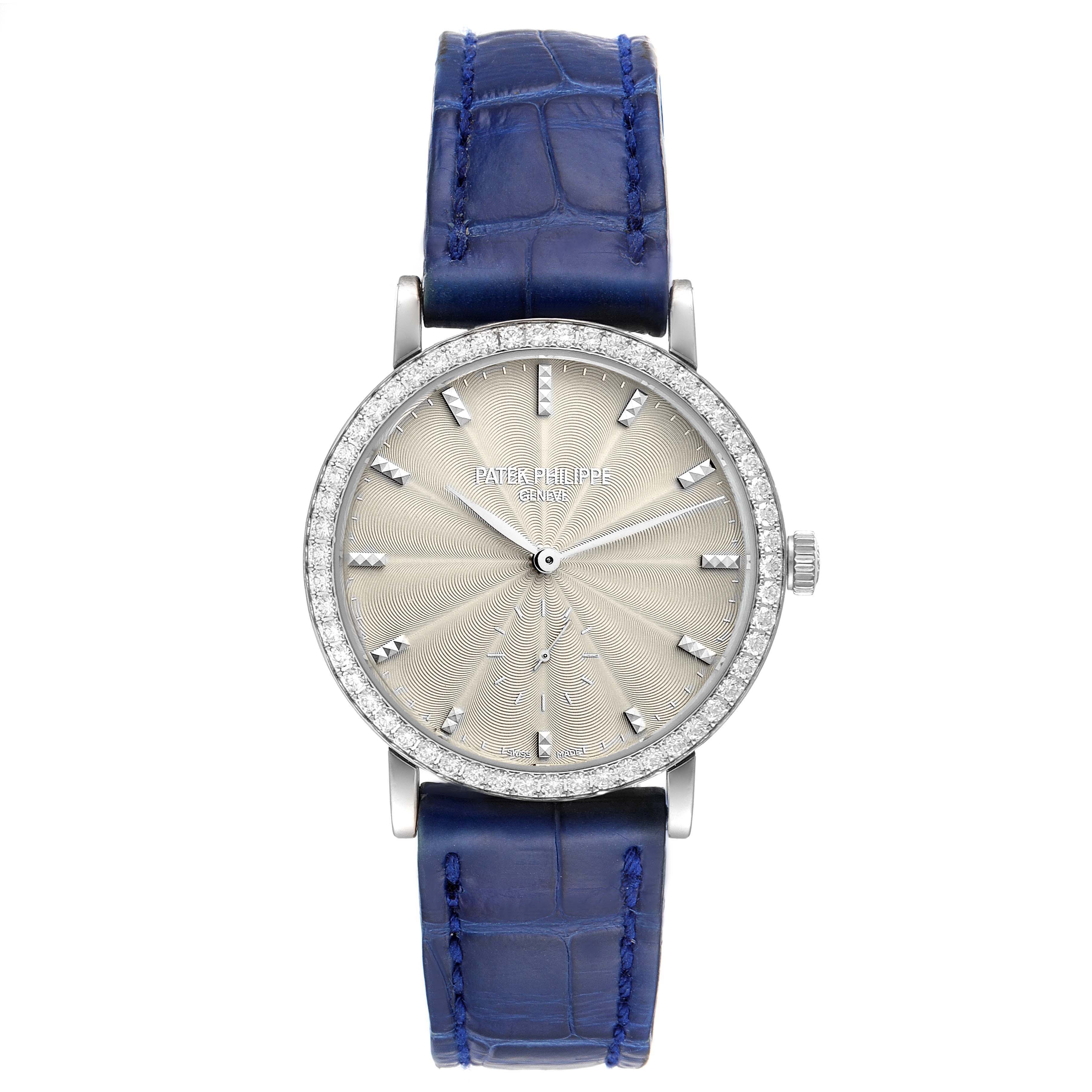 This is a front-facing view of a Patek Philippe Calatrava 7120G Women's White Gold Beige Dial 7120G Women's White Gold Beige Dial watch with a blue strap and diamond-studded bezel.