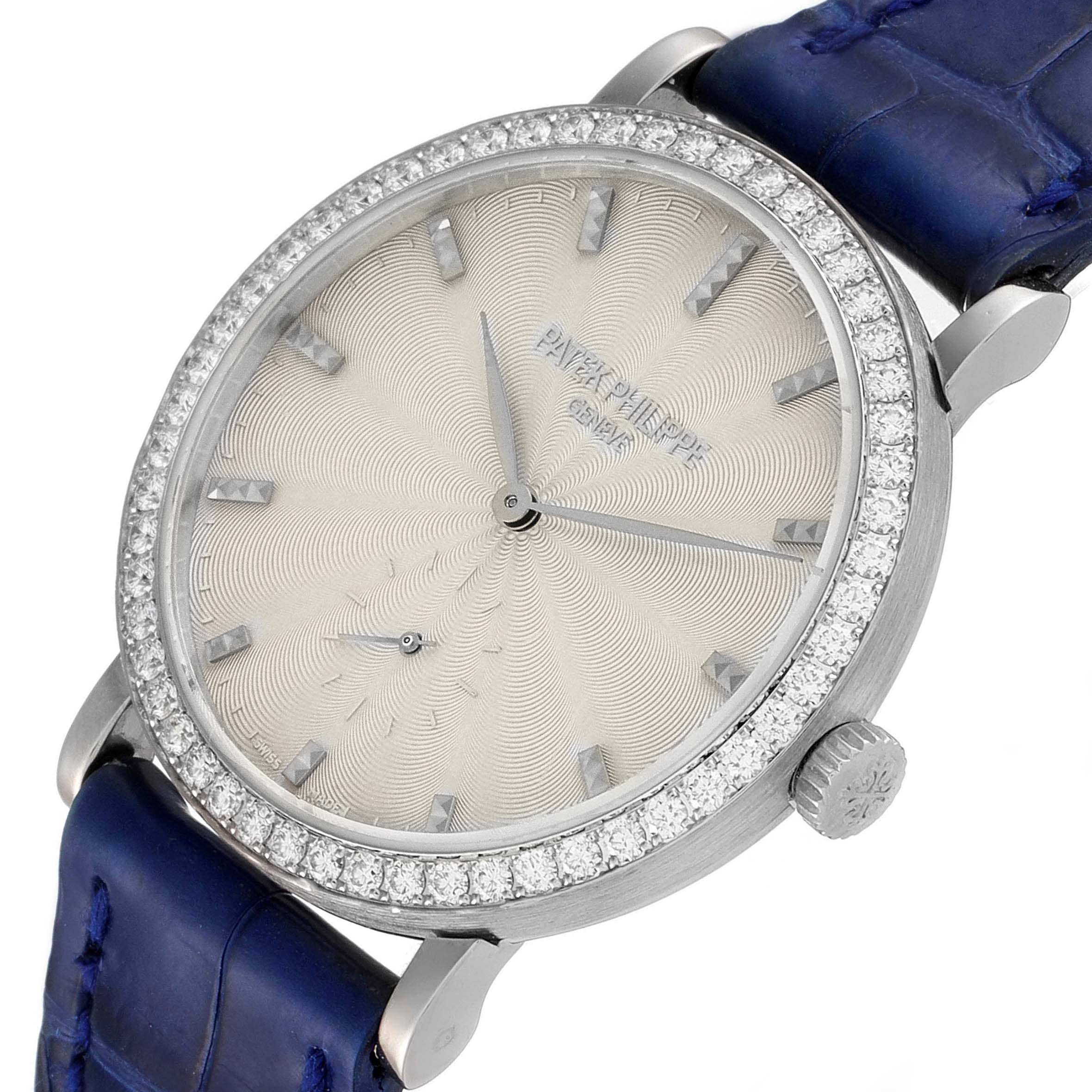 This image shows a close-up view of the Patek Philippe Calatrava 7120G Women's White Gold Beige Dial 7120G Women's White Gold Beige Dial model watch face, bezel, crown, and blue leather strap.