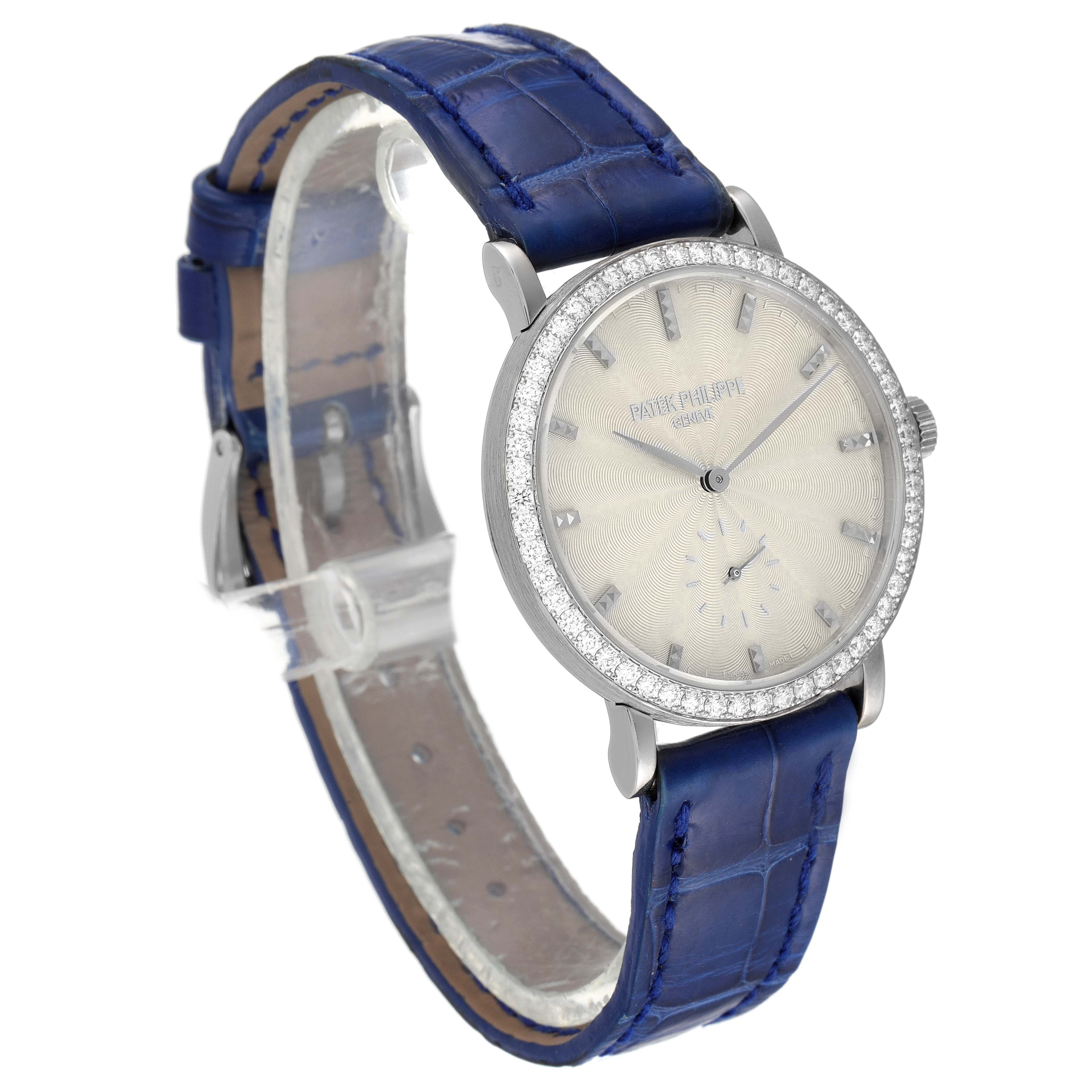 The image shows a Patek Philippe Calatrava 7120G Women's White Gold Beige Dial 7120G Women's White Gold Beige Dial watch at an angle displaying the face, bezel, and blue leather strap.