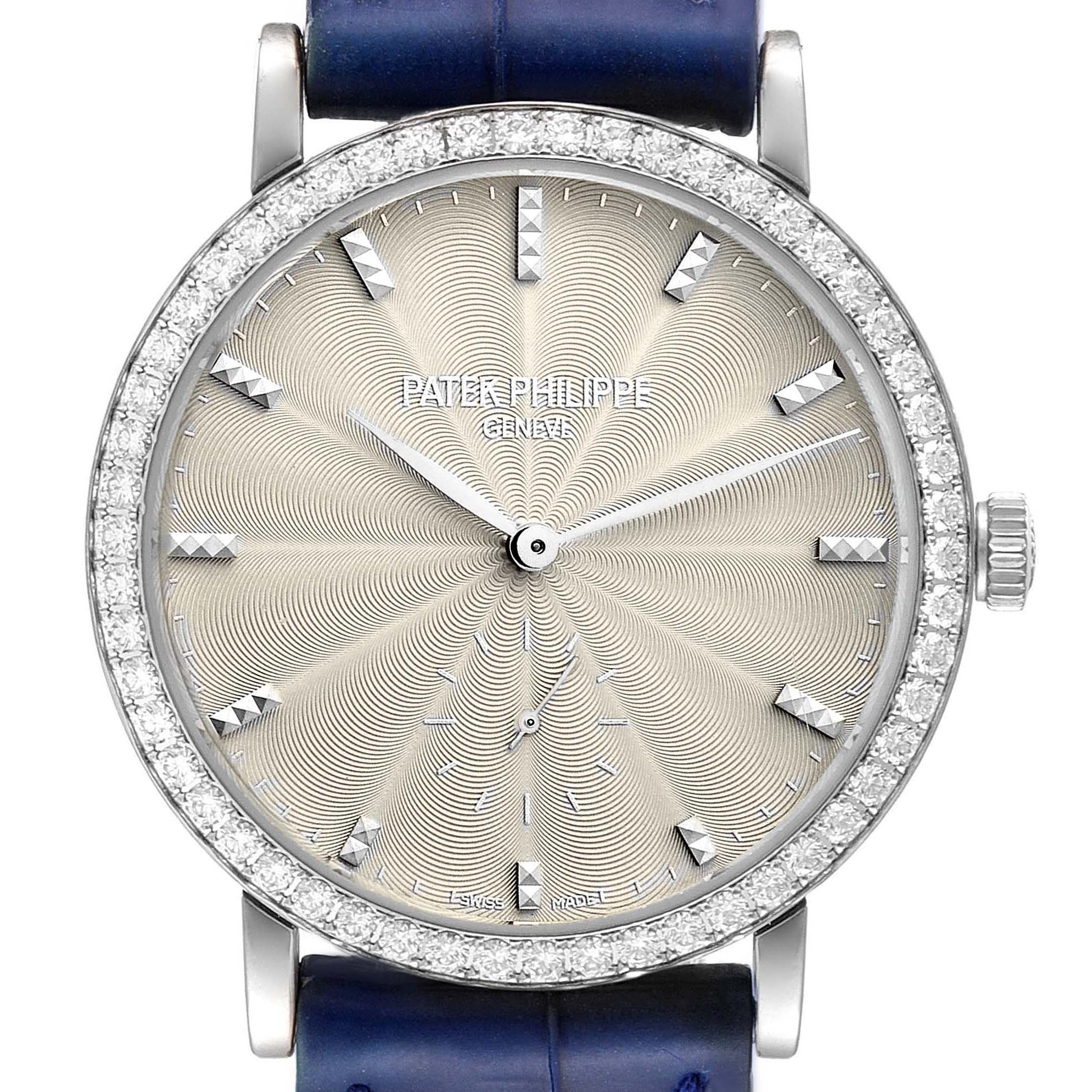 The image shows a front view of a Patek Philippe Calatrava 7120G Women's White Gold Beige Dial 7120G Women's White Gold Beige Dial watch, highlighting its intricate dial, diamond bezel, and blue strap.