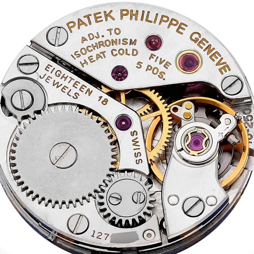 The image shows a top-down view of the Patek Philippe Golden Ellipse 4223 Women's Yellow Gold Blue Dial 4223 Women's Yellow Gold Blue Dial watch movement, highlighting gears and jewels.