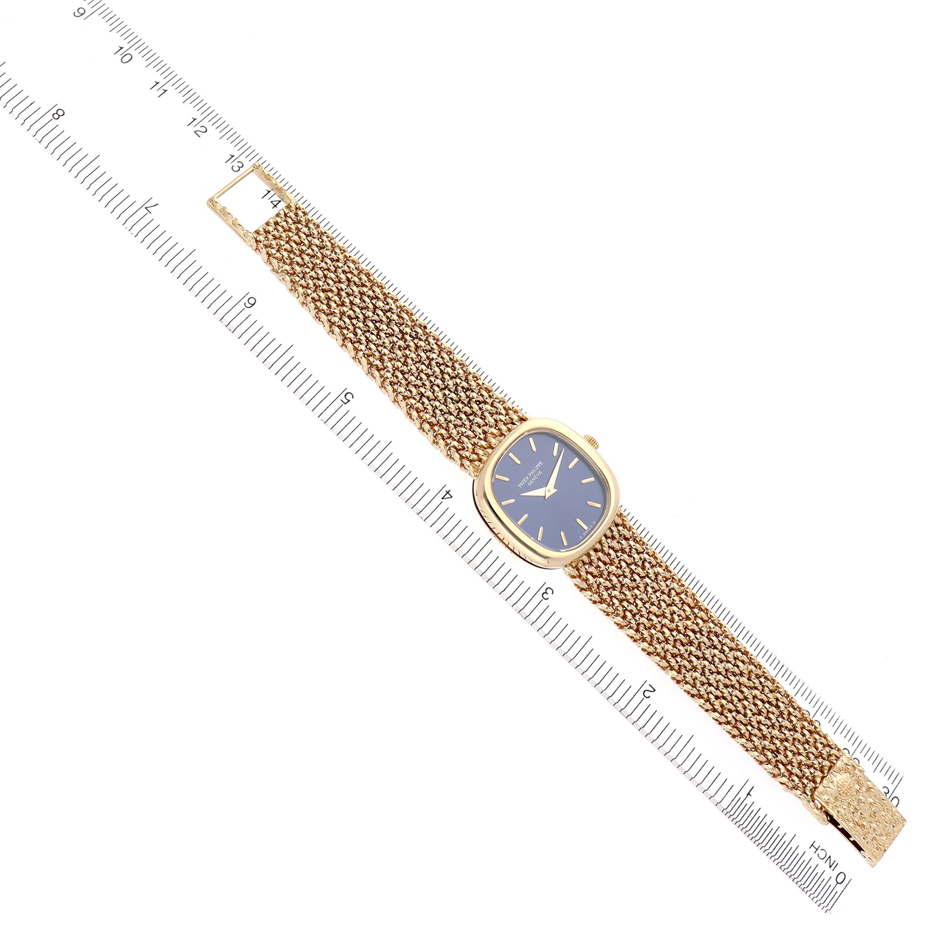 The Patek Philippe Golden Ellipse 4223 Women's Yellow Gold Blue Dial 4223 Women's Yellow Gold Blue Dial watch is shown from a top-down angle, displaying the face, case, and gold bracelet.