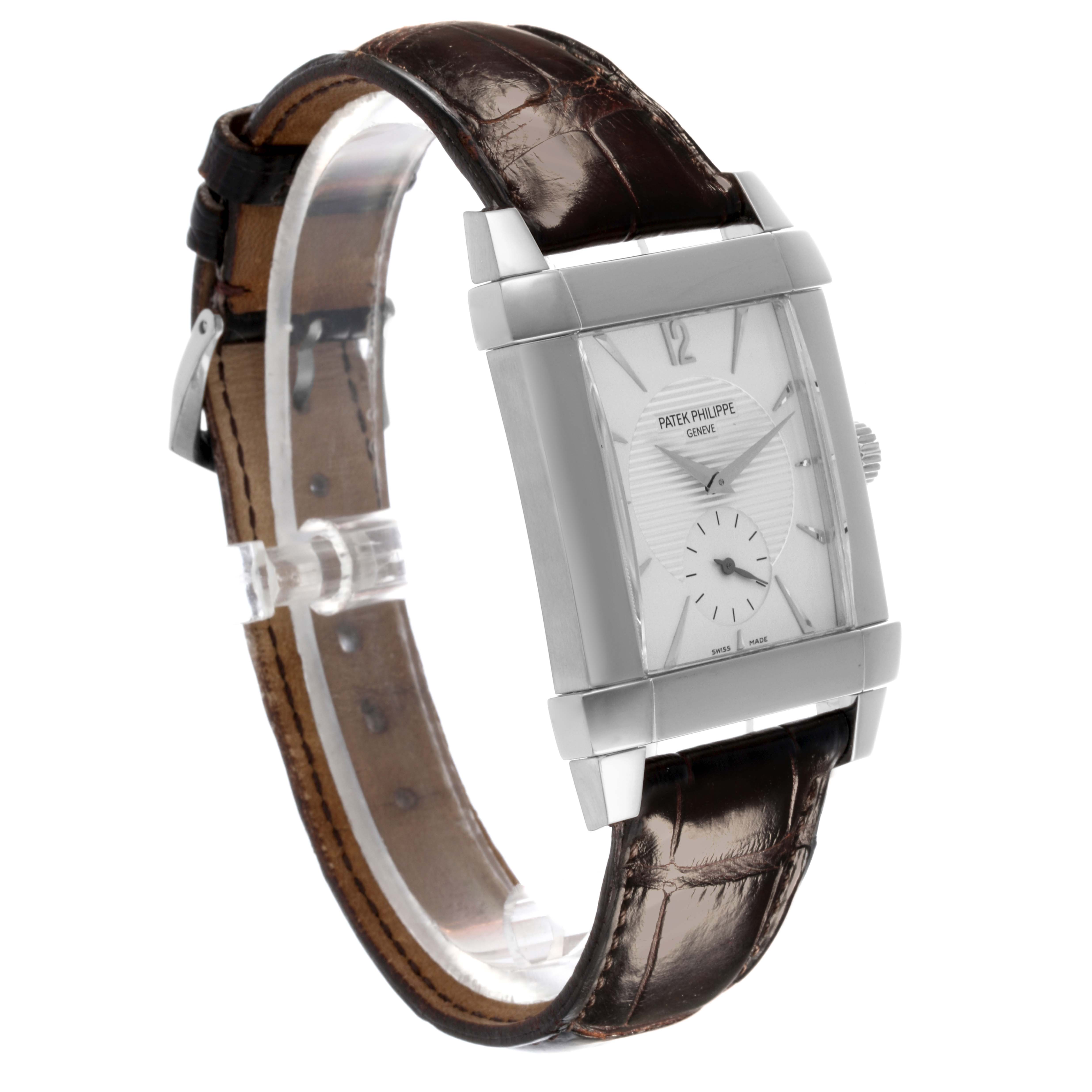 The Patek Philippe Gondolo 5111G-001 Men's White Gold Silver Dial 5111G-001 Men's White Gold Silver Dial watch is shown at a three-quarter angle, highlighting the rectangular face, side profile, and leather strap.