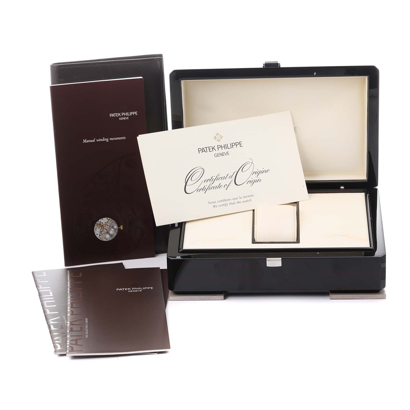 The image shows the open box and documents for the Patek Philippe Gondolo 5111G-001 Men's White Gold Silver Dial 5111G-001 Men's White Gold Silver Dial watch, including a certificate and manual.