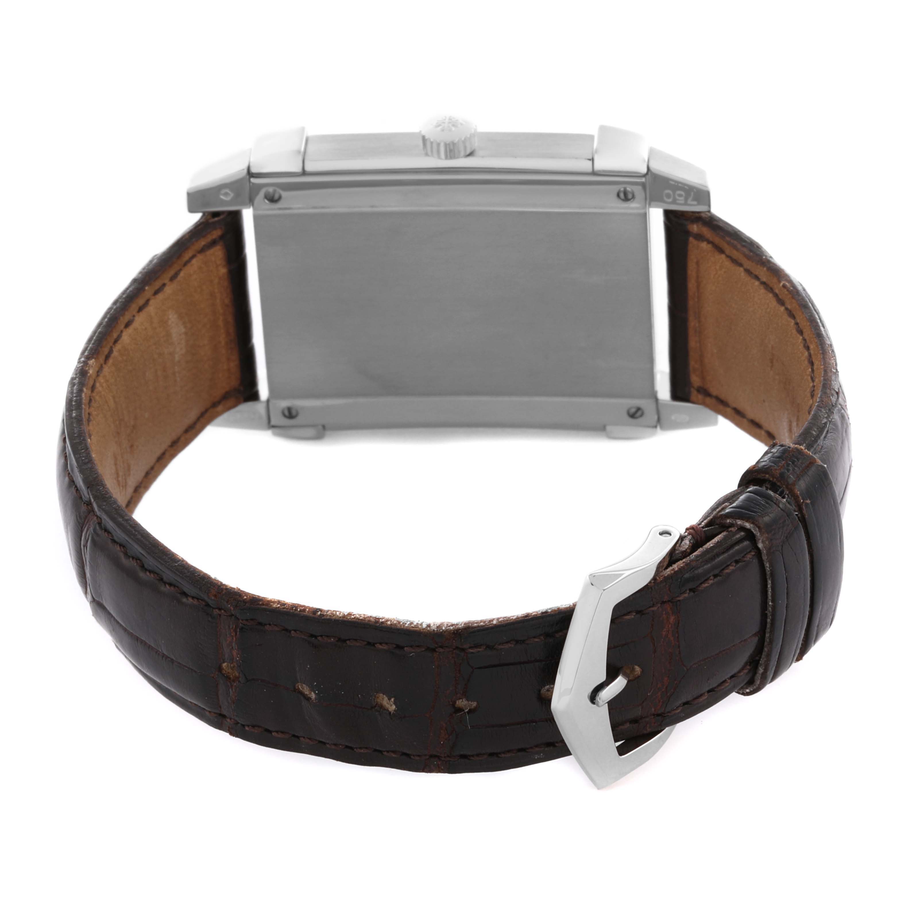 The image shows a Patek Philippe Gondolo 5111G-001 Men's White Gold Silver Dial 5111G-001 Men's White Gold Silver Dial watch from the back, highlighting its rectangular case, crown, and brown leather strap with a buckle.