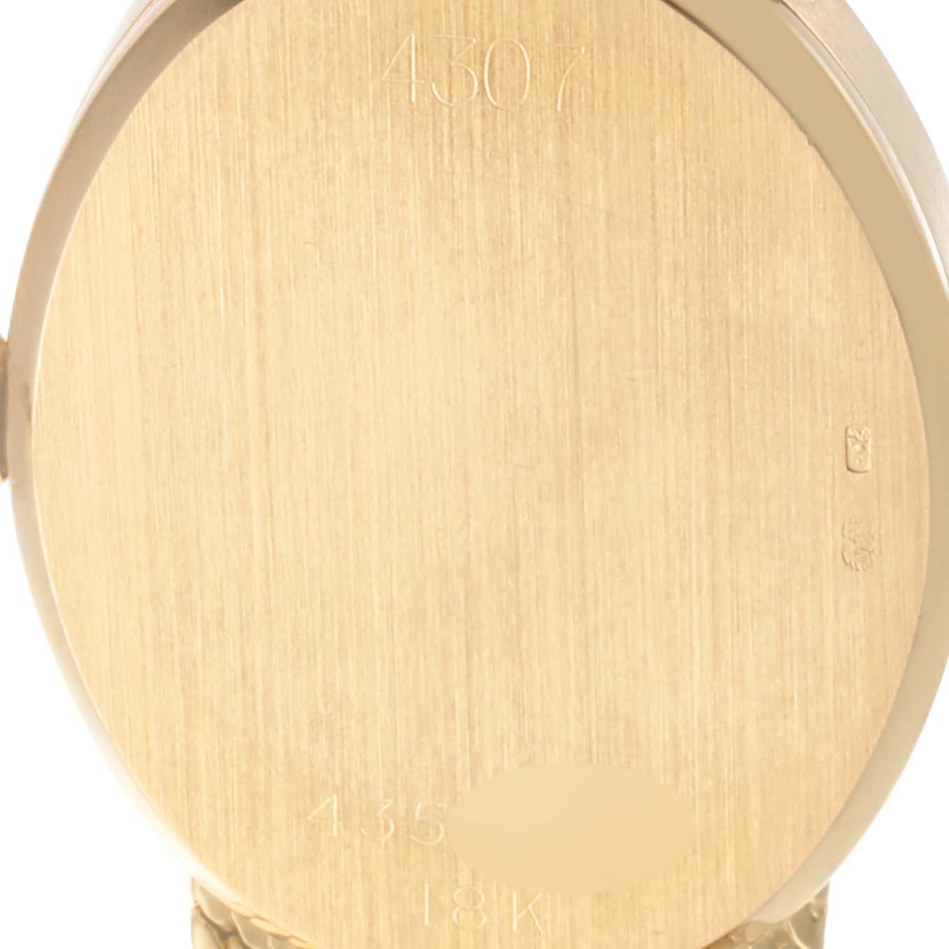 The image shows the back case of a Rolex Cellini 4307 Women's Yellow Gold Champagne Dial 4307 Women's Yellow Gold Champagne Dial watch, highlighting its gold surface and inscriptions.