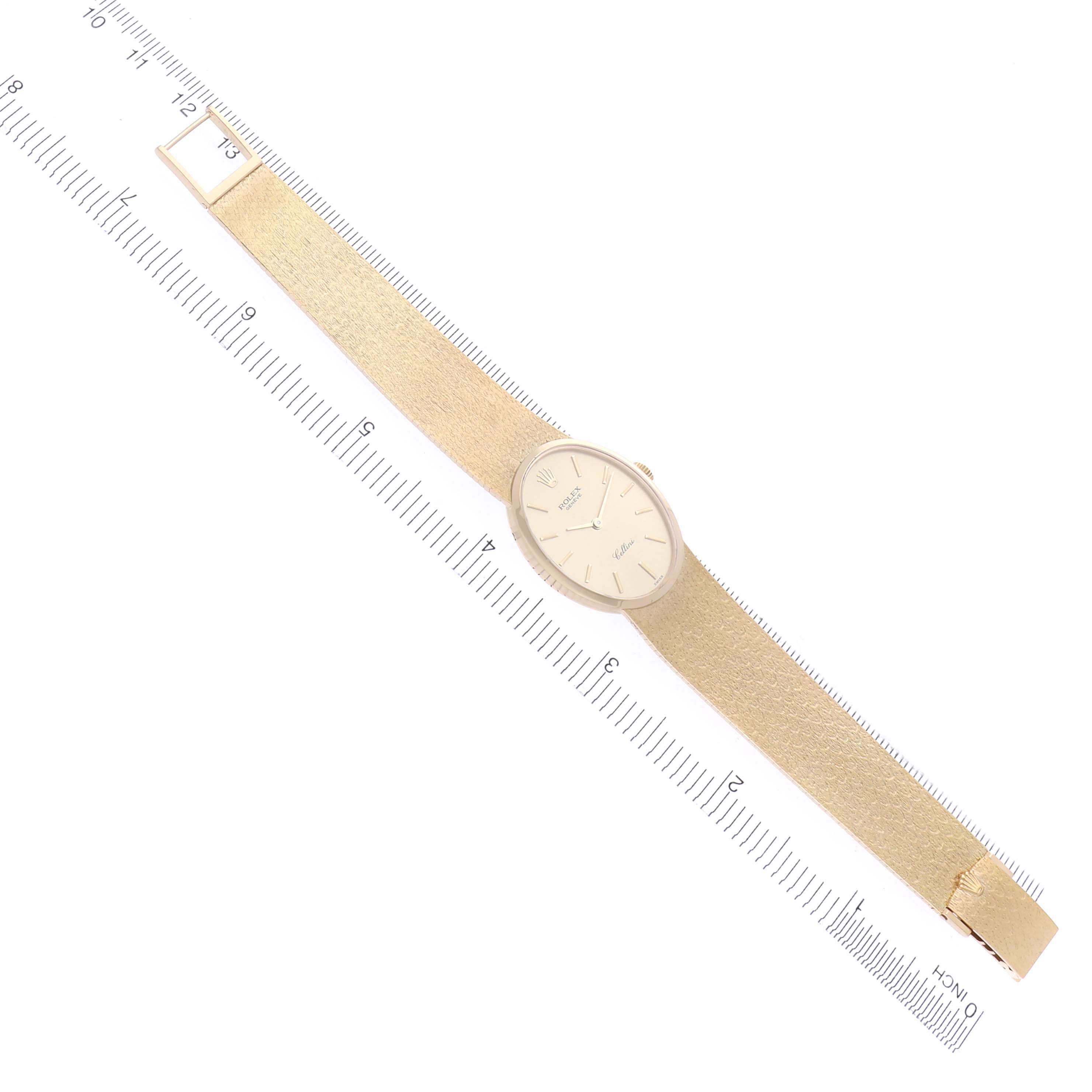 The Rolex Cellini 4307 Women's Yellow Gold Champagne Dial 4307 Women's Yellow Gold Champagne Dial watch is shown from a top-down angle, displaying the watch face and full band along a ruler.