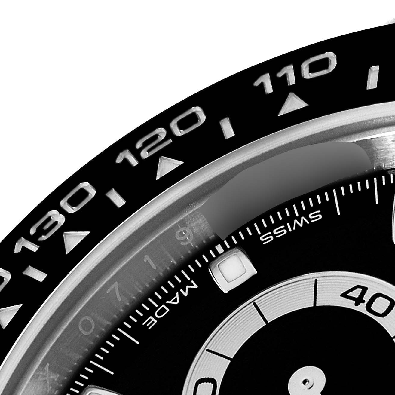 The image shows a close-up of the bezel and partial dial of a Rolex Daytona 116500 Men's Stainless Steel Black Dial 116500 Men's Stainless Steel Black Dial watch, with visible tachymeter scale marking.