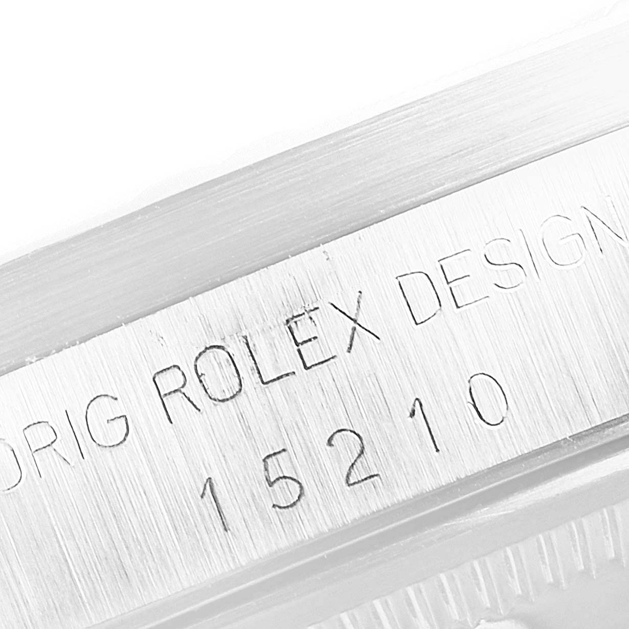 The image shows a close-up of the Rolex Date 15210 Men's Stainless Steel Silver Dial 15210 Men's Stainless Steel Silver Dial model's case with the reference number 15210 engraved.