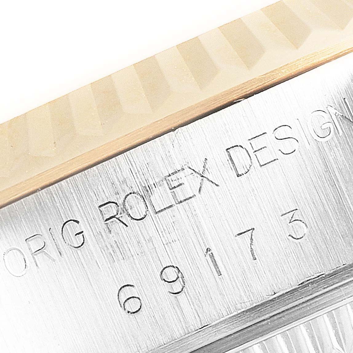 The image shows a close-up of the bezel and case body of a Rolex Datejust 69173 Women
s Steel and Gold (two tone) Champagne Dial 69173 Women
s Steel and Gold (two tone) Champagne Dial, focusing on the model engraving.