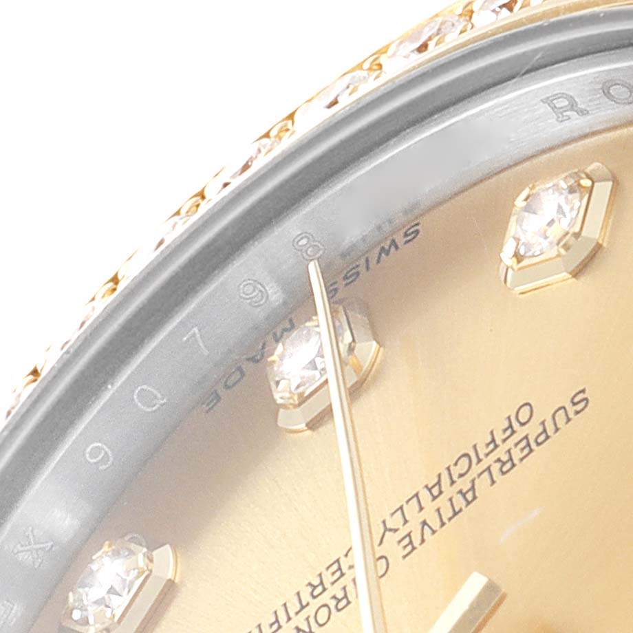 The image shows a close-up of the dial and bezel with diamond hour markers of a Mid-Size Rolex watch.
