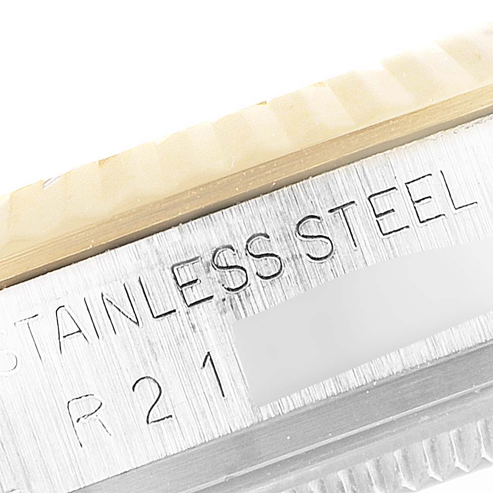 The image shows a close-up of the bezel and part of the casing of the Rolex Vintage Collection 16013 Men's Steel and Gold (two tone) Champagne Dial 16013 Men's Steel and Gold (two tone) Champagne Dial watch, highlighting "STAINLESS STEEL" engraving.