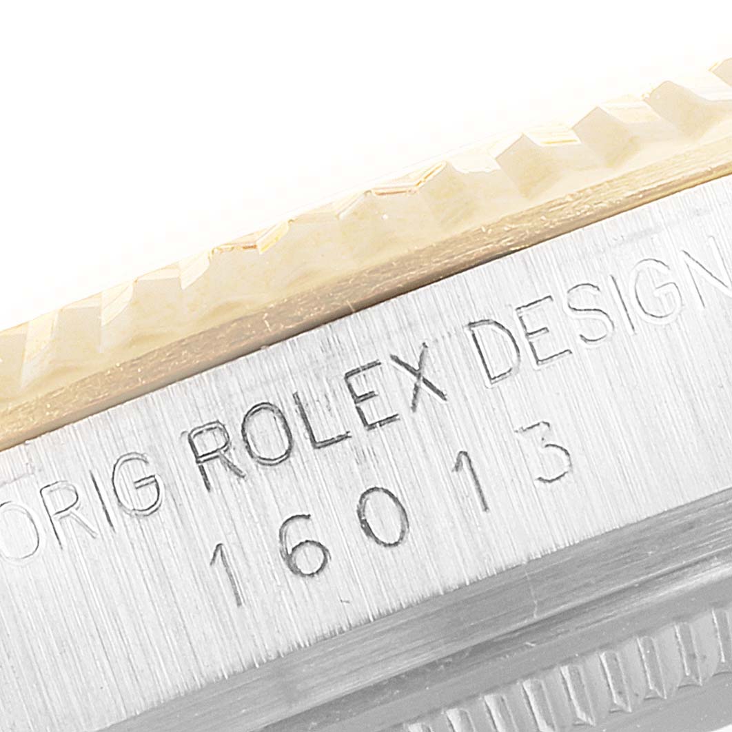 This close-up shows the engraved case side of a Rolex Datejust 16013 Men's Steel and Gold (two tone) Champagne Dial 16013 Men's Steel and Gold (two tone) Champagne Dial model, highlighting the fluted bezel and part of the serial number.
