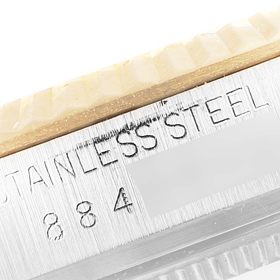 Close-up of the bezel and case edge of a Rolex Datejust 16013 Men's Steel and Gold (two tone) Champagne Dial 16013 Men's Steel and Gold (two tone) Champagne Dial watch, showing the "STAINLESS STEEL" engraving.