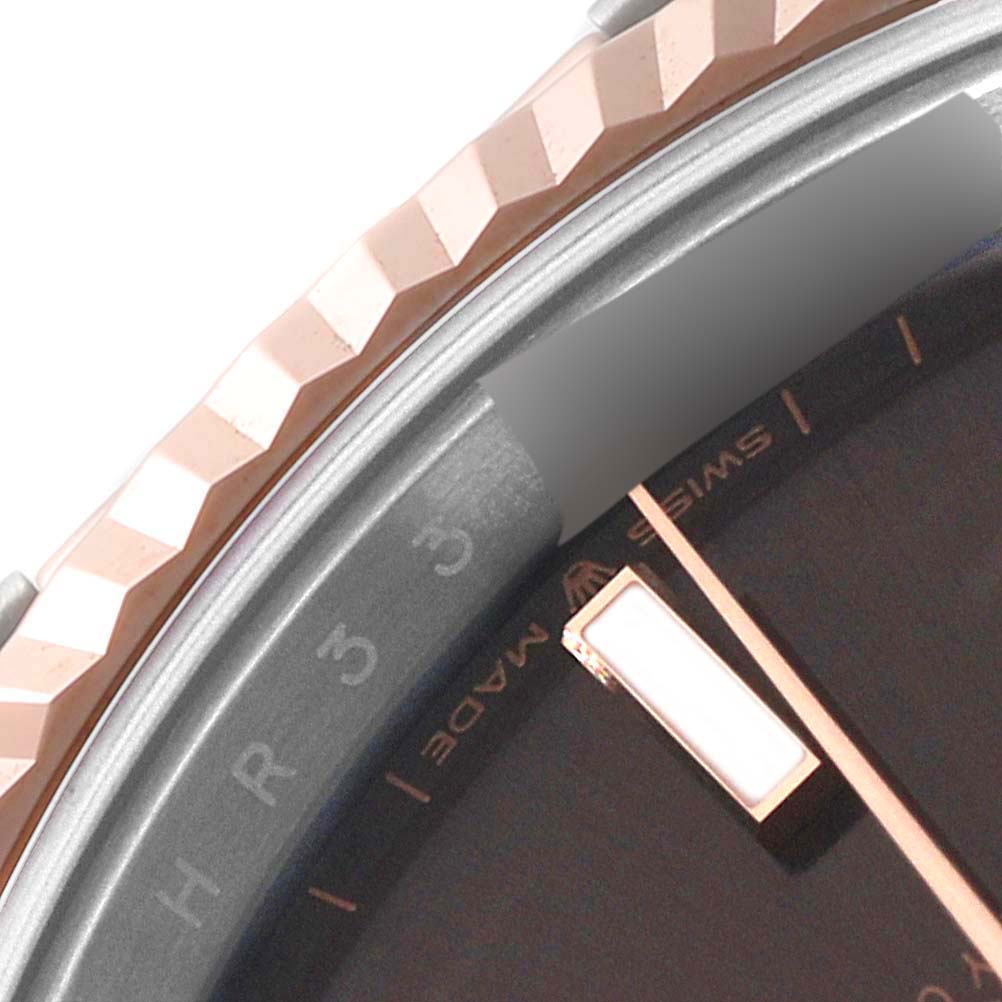 Close-up of the bezel and dial of the Rolex Datejust 41 126331 Men's Steel and Gold (two tone) Brown Dial 126331 Men's Steel and Gold (two tone) Brown Dial watch, showing part of the minute track and hour marker.