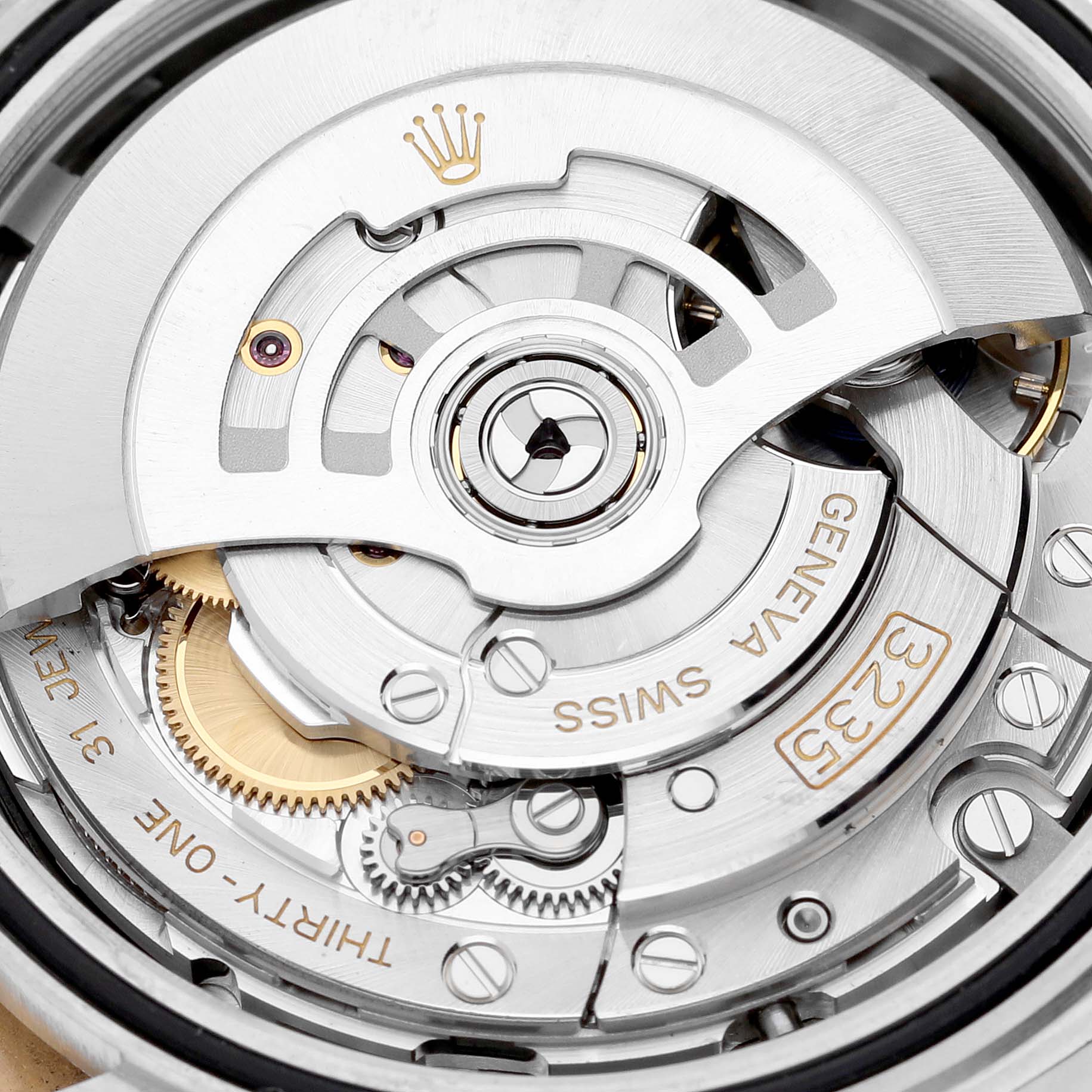 The image shows an up-close view of the movement mechanism of the Rolex Datejust 41 126333 Men's Steel and Gold (two tone) Black Dial 126333 Men's Steel and Gold (two tone) Black Dial, highlighting the intricate gears and rotor.
