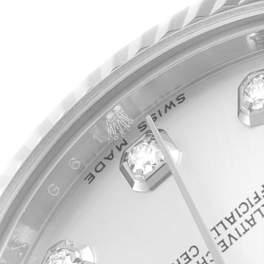 This close-up image of the Mid-Size Rolex watch shows part of the bezel, a hand, two hour markers, and the text "SWISS MADE."