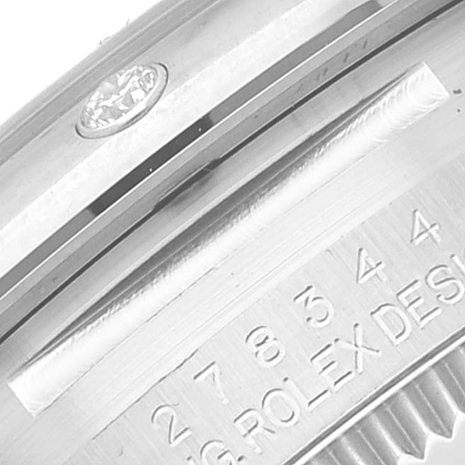 The image shows a close-up, angled view of the case and serial number area on a Mid-Size Rolex watch.