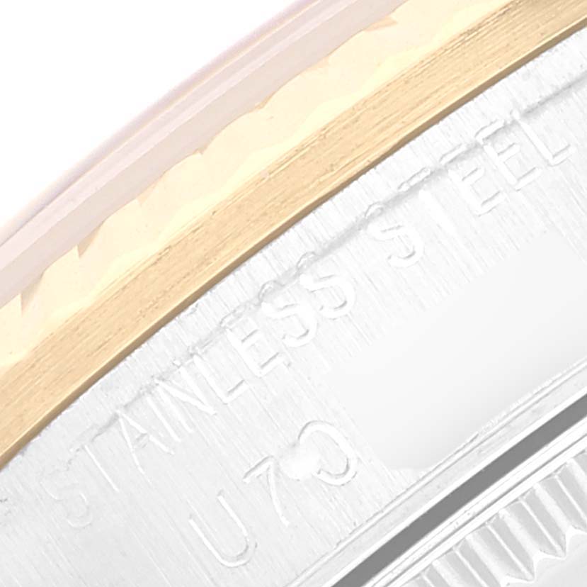 This close-up image of a Rolex Mid-Size 78273 Women
s Steel and Gold (two tone) Black Dial 78273 Women
s Steel and Gold (two tone) Black Dial model watch shows part of the stainless steel case back, revealing the text "STAINLESS STEEL."