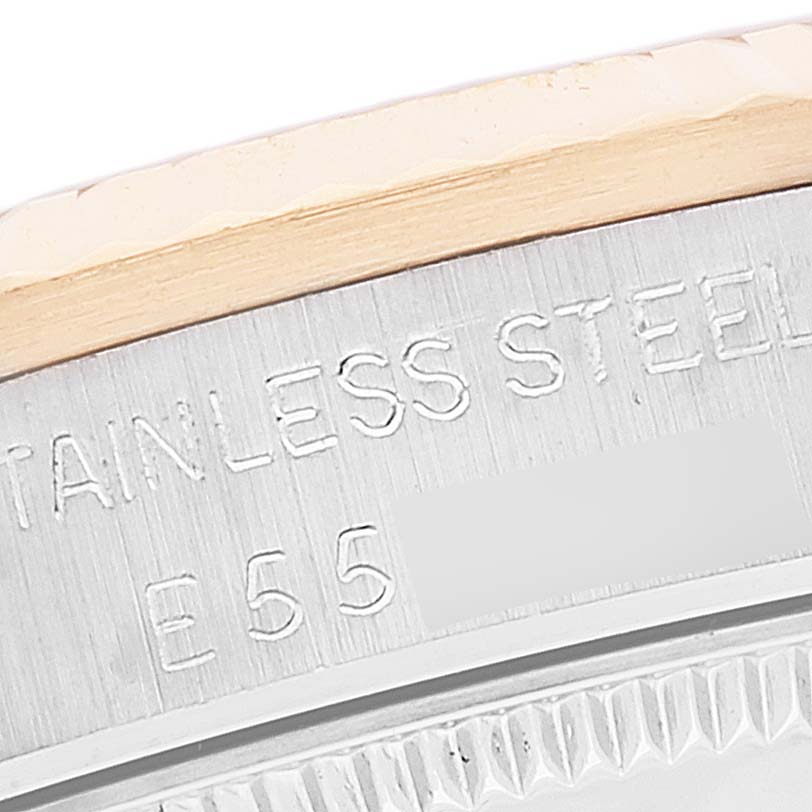 This image shows a close-up of the engraved stainless steel casing of a Mid-Size Rolex watch.