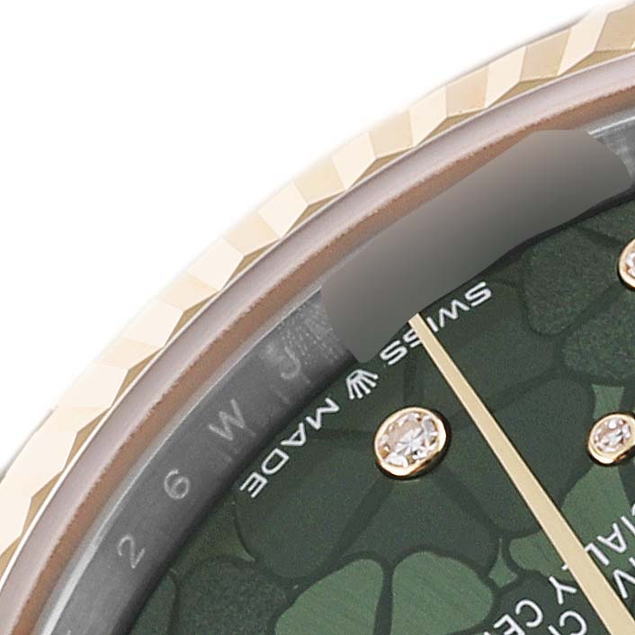 This image shows a close-up angle of the dial, bezel, and part of the face of a Mid-Size Rolex watch.