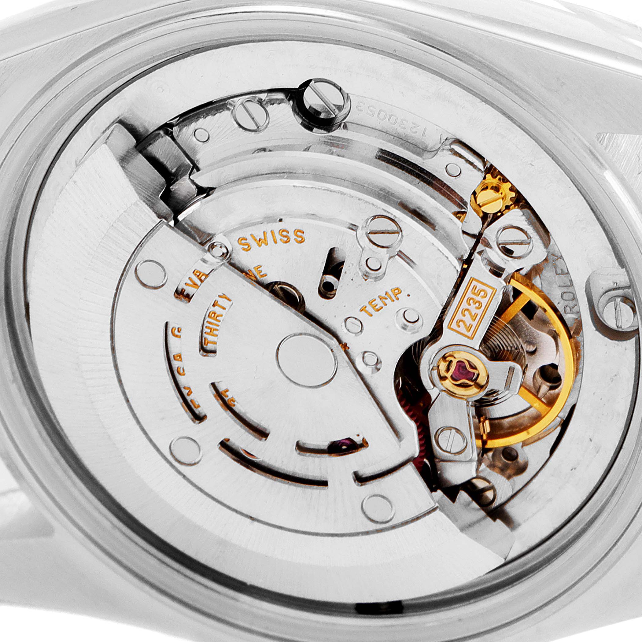 This image shows the intricate internal movement of a Mid-Size Rolex watch, highlighting its mechanical components.