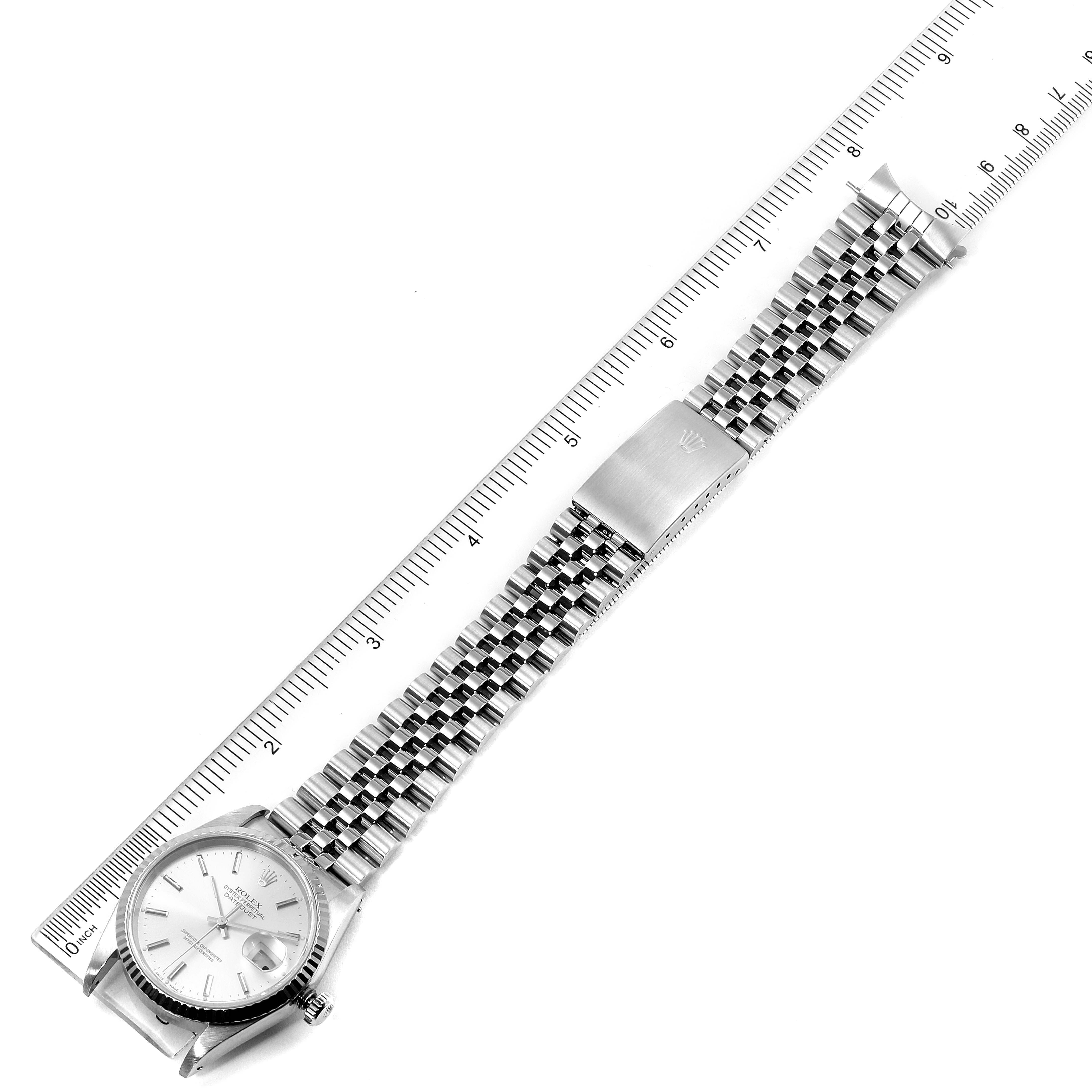 This image shows a top view of a Rolex Datejust 16234 Men's Stainless Steel Silver Dial 16234 Men's Stainless Steel Silver Dial watch, displaying the dial, bracelet, and clasp alongside a measuring ruler.
