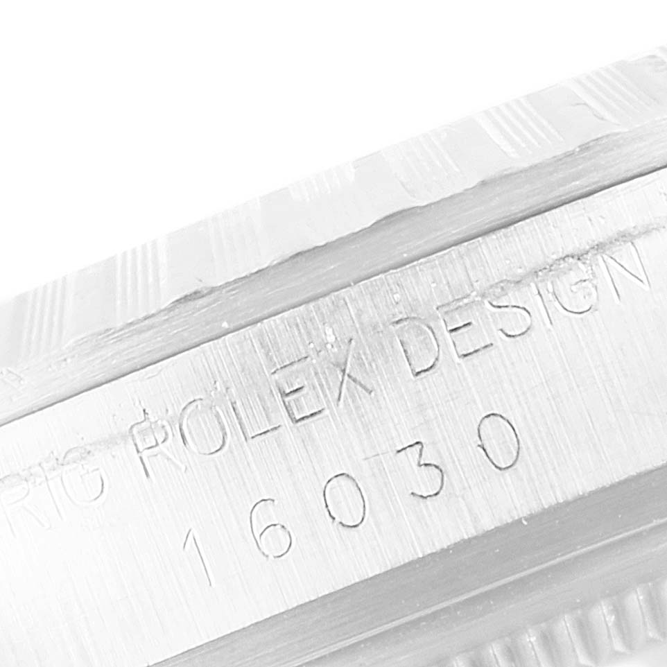 This close-up image shows the model number "16030" and "ROLEX DESIGN" engraved on the side of the Rolex Vintage Collection 16030 Men's Stainless Steel Silver Dial 16030 Men's Stainless Steel Silver Dial watch case.