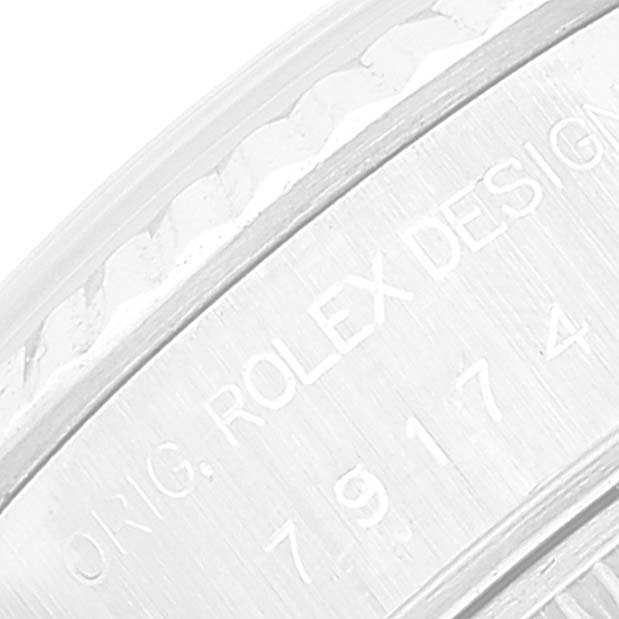 This macro shot shows a portion of the bezel and engraved serial number on a Rolex Datejust 79174 Women's Stainless Steel Blue Dial 79174 Women's Stainless Steel Blue Dial watch.