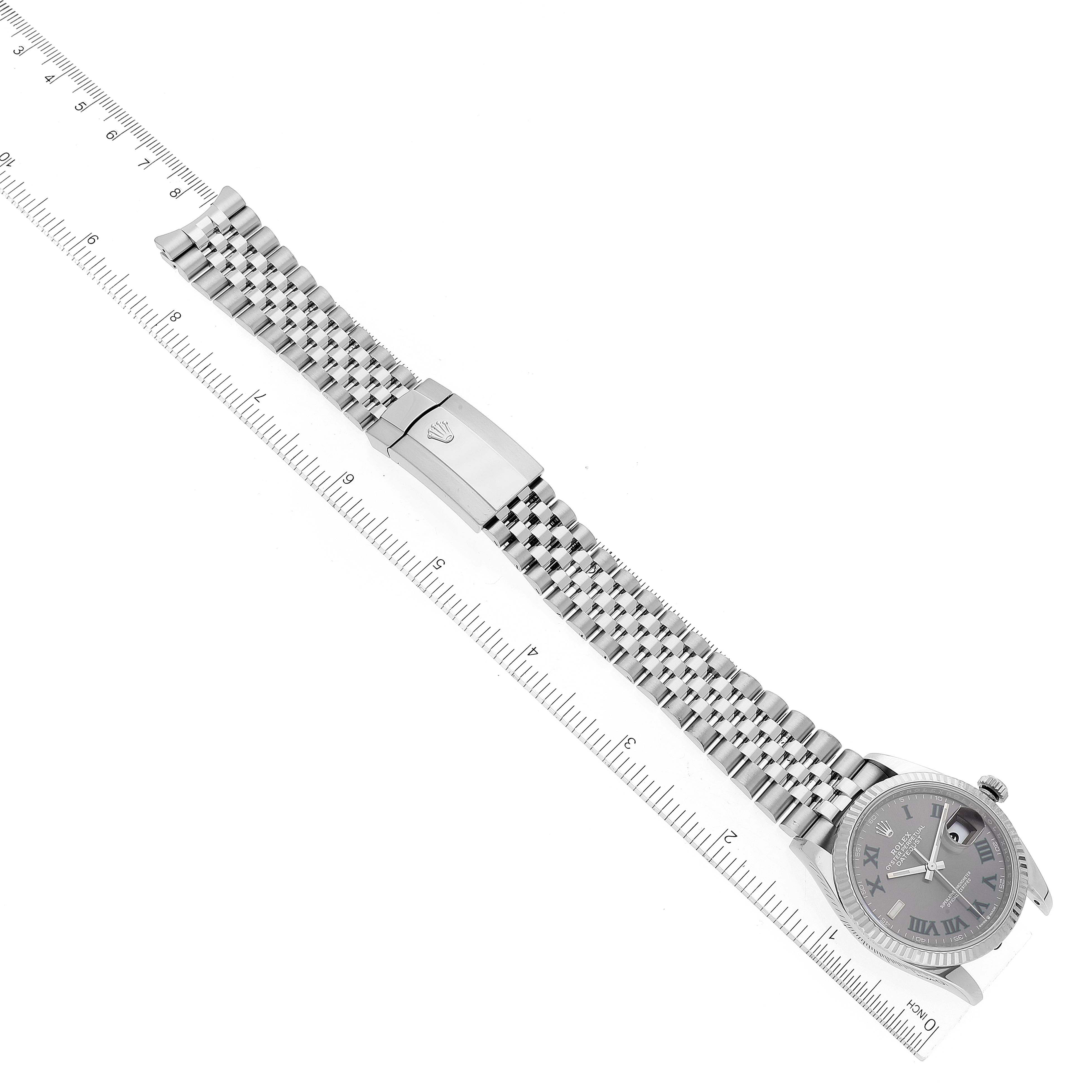 The image displays a laid-flat Rolex Datejust 126234 Men's Stainless Steel Grey Dial 126234 Men's Stainless Steel Grey Dial watch, showing the face, Jubilee bracelet, and clasp, alongside a ruler for scale.