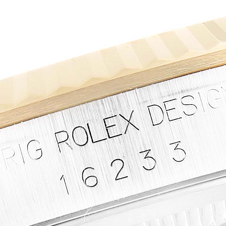This close-up image shows the rim and model inscription of a Rolex Datejust 16233 Men's Steel and Gold (two tone) Black Dial 16233 Men's Steel and Gold (two tone) Black Dial watch.