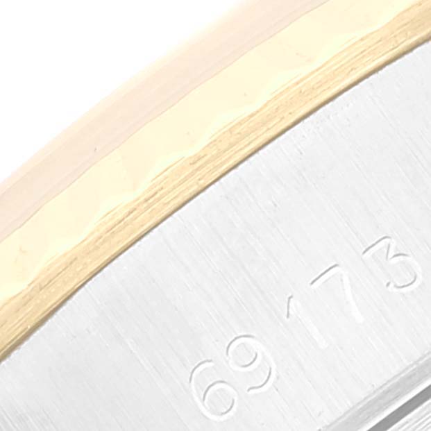 This close-up of a Rolex Datejust 69173 Women's Steel and Gold (two tone) Champagne Dial 69173 Women's Steel and Gold (two tone) Champagne Dial watch shows part of the bezel and case with the model number engraved.