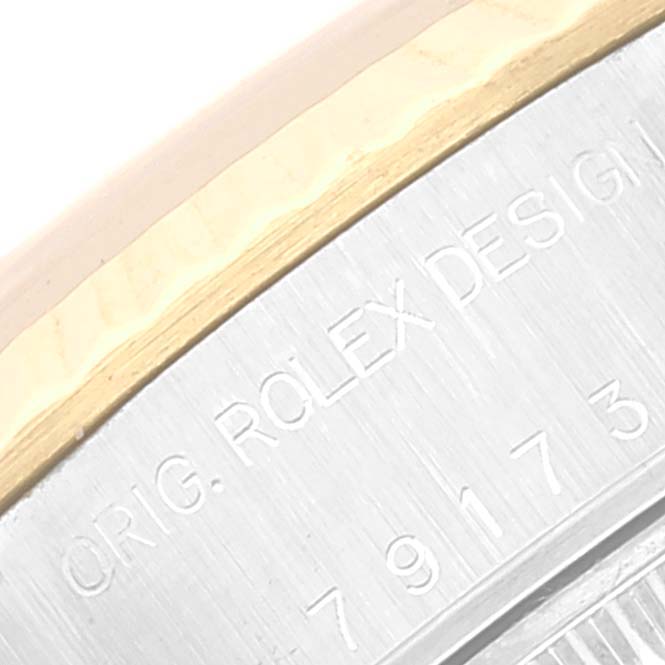 The image shows a partial view of the side case of a Rolex Datejust 79173 Women's Steel and Gold (two tone) Champagne Dial 79173 Women's Steel and Gold (two tone) Champagne Dial watch, highlighting the engraving "ORIG. ROLEX DESIGN" and part of the serial number.