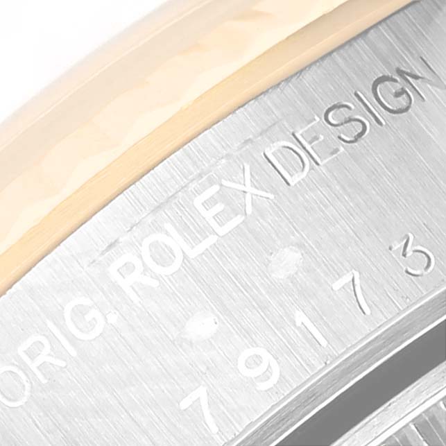 Close-up angle showing the side engraving of the Rolex Datejust 79173G Women's Steel and Gold (two tone) Champagne Dial 79173G Women's Steel and Gold (two tone) Champagne Dial watch case, featuring branding and serial numbers.