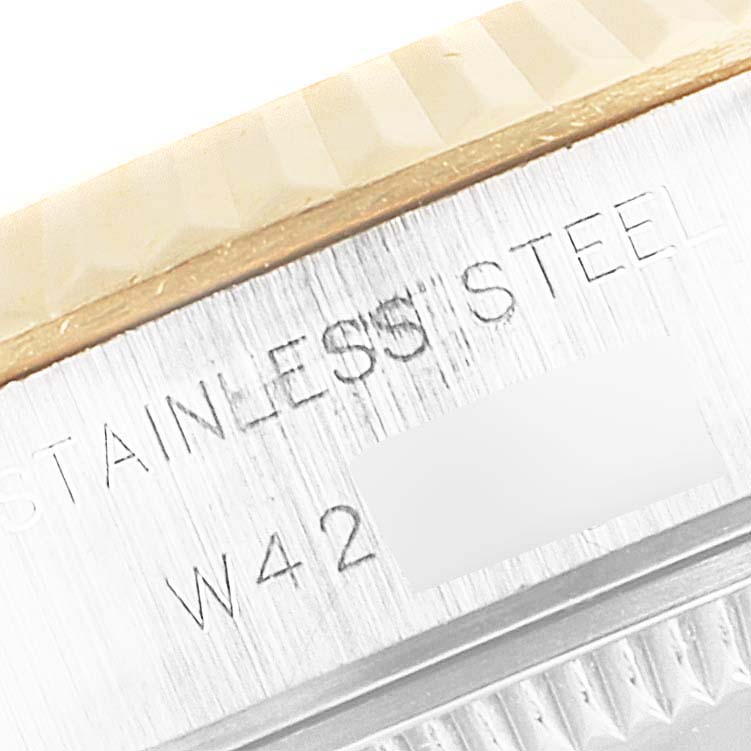 The image shows a close-up of the case side of a Rolex Datejust 69173 Women
s Steel and Gold (two tone) Champagne Dial 69173 Women
s Steel and Gold (two tone) Champagne Dial watch, highlighting the "STAINLESS STEEL" engraving.