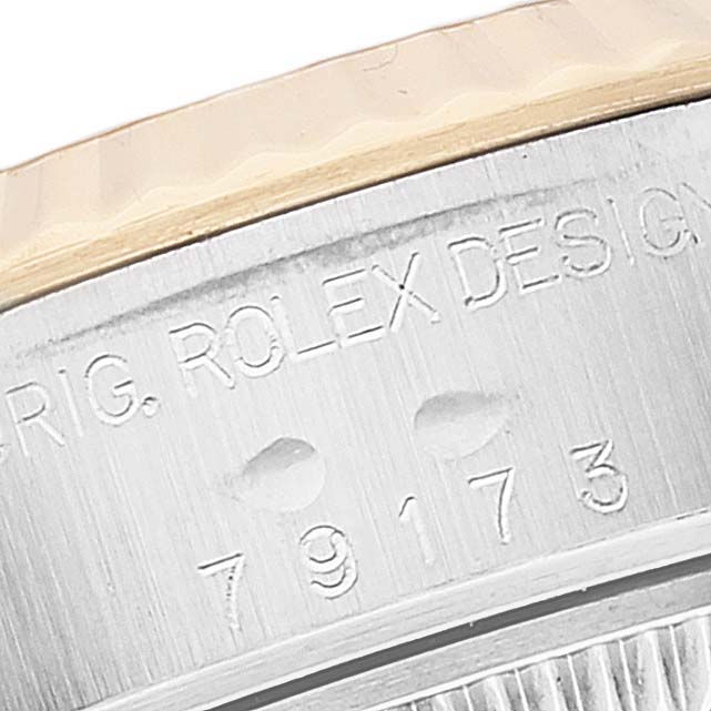 The image shows an angled close-up of the serial number engraving on the case side of a Rolex Datejust 79173 Women's Steel and Gold (two tone) Silver Dial 79173 Women's Steel and Gold (two tone) Silver Dial watch.