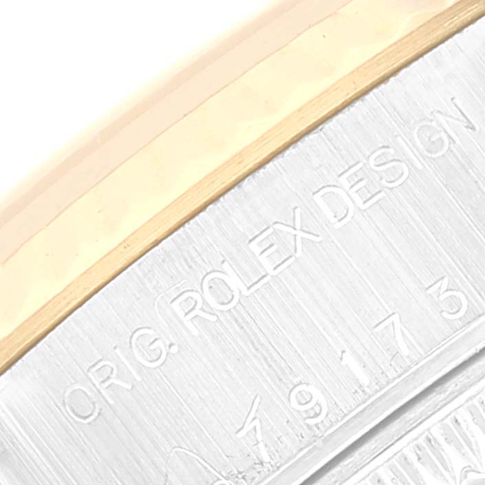 The image shows a close-up of the CR. G. ROLEX DESIGN engraving on the Rolex Datejust 79173 Women's Steel and Gold (two tone) Silver Dial 79173 Women's Steel and Gold (two tone) Silver Dial model bezel and case.
