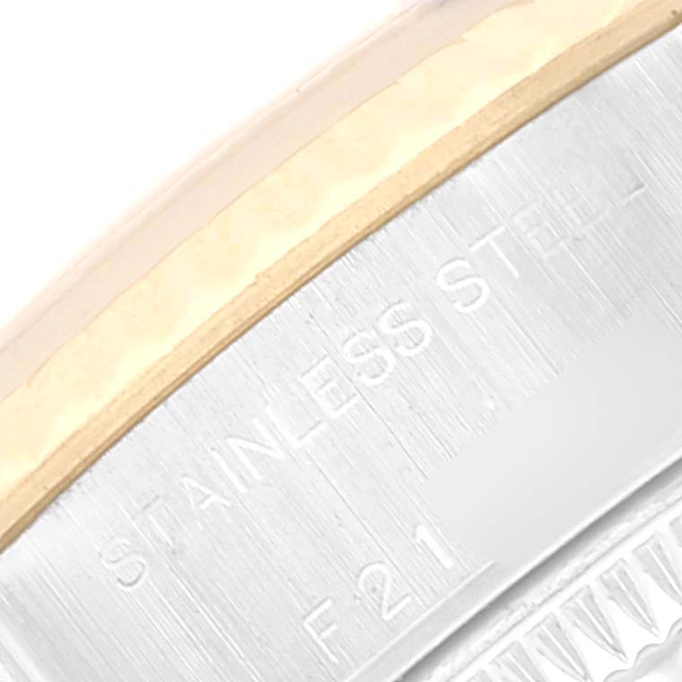 This close-up image of the Rolex Datejust 79173 Women's Steel and Gold (two tone) Silver Dial 79173 Women's Steel and Gold (two tone) Silver Dial model shows part of the bezel and the engraved stainless steel casing.