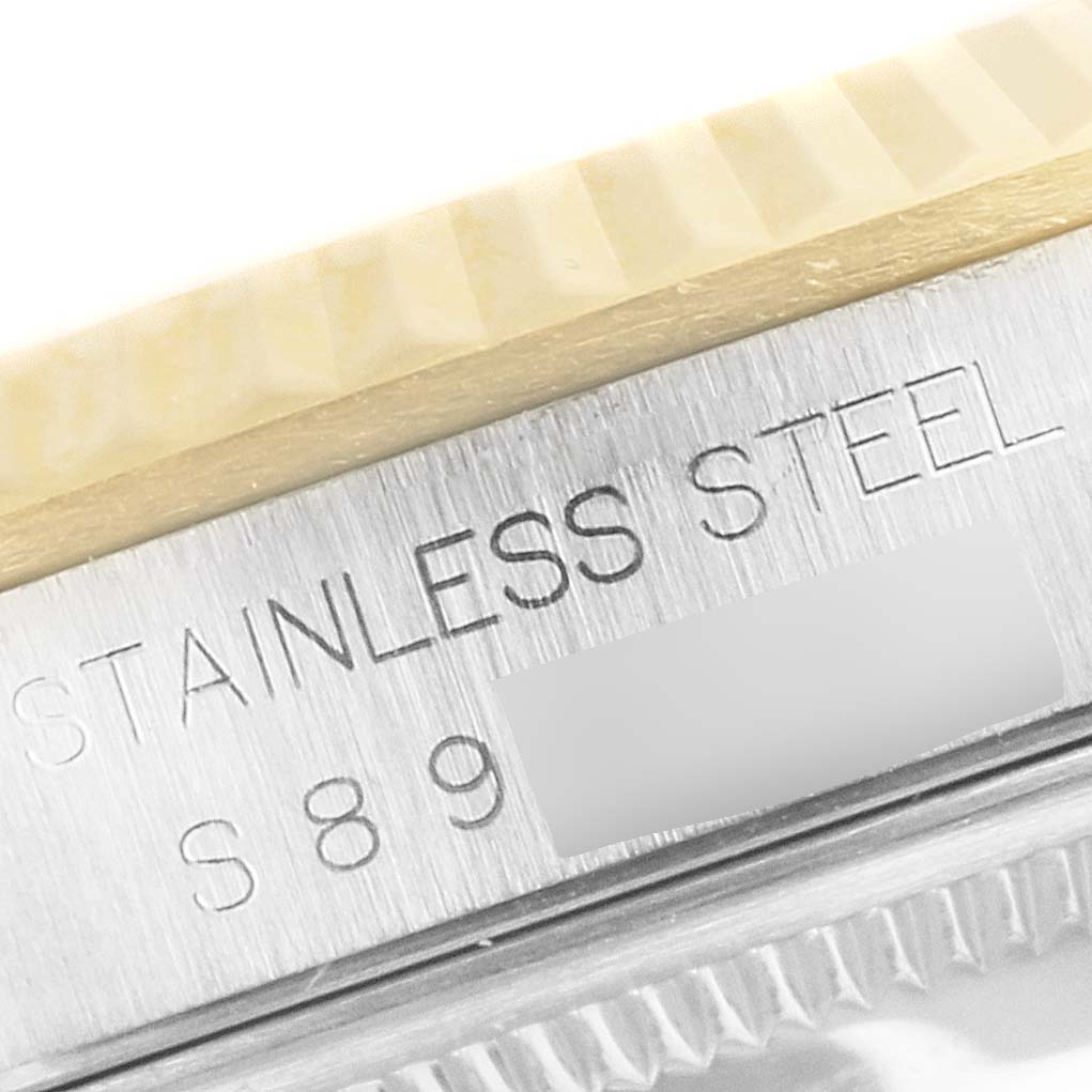 The image shows a close-up of the stainless steel casing with engraved text on a Rolex Datejust 16233 Men's Steel and Gold (two tone) Champagne Dial 16233 Men's Steel and Gold (two tone) Champagne Dial watch.