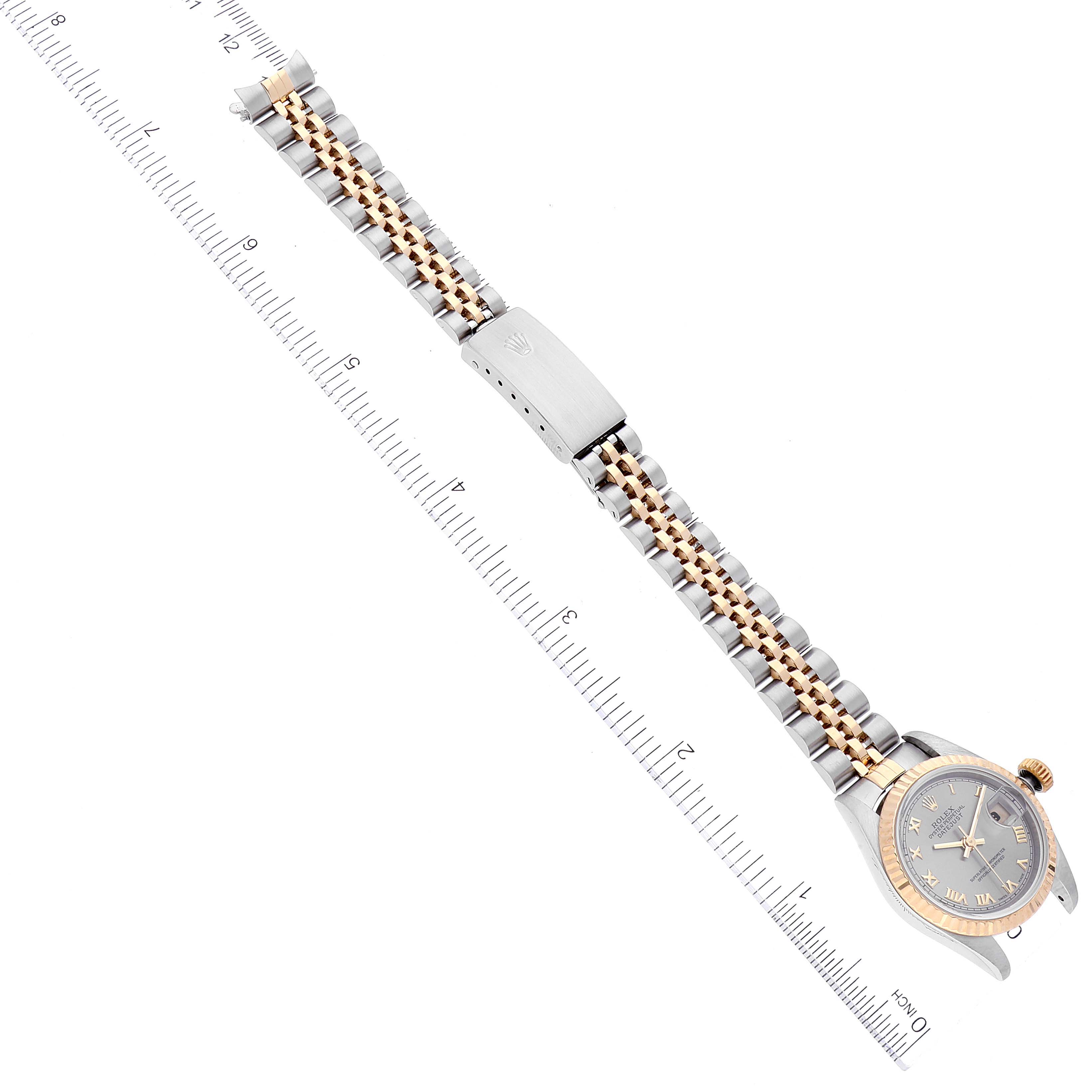 The image shows a full view of a Rolex Datejust 69173 Women's Steel and Gold (two tone) Grey Dial 69173 Women's Steel and Gold (two tone) Grey Dial watch, including its face, bezel, bracelet, and clasp, positioned next to a ruler.