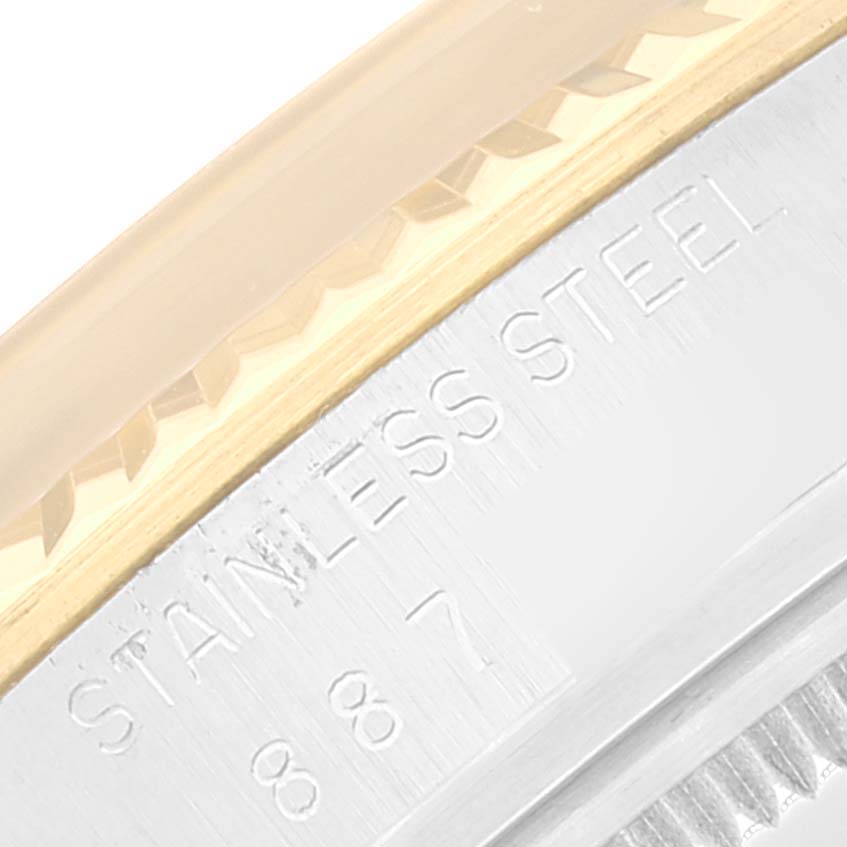 This close-up image shows a partial view of the bezel and the "STAINLESS STEEL" engraving on a Rolex Datejust 16013 Men's Steel and Gold (two tone) White Dial 16013 Men's Steel and Gold (two tone) White Dial.