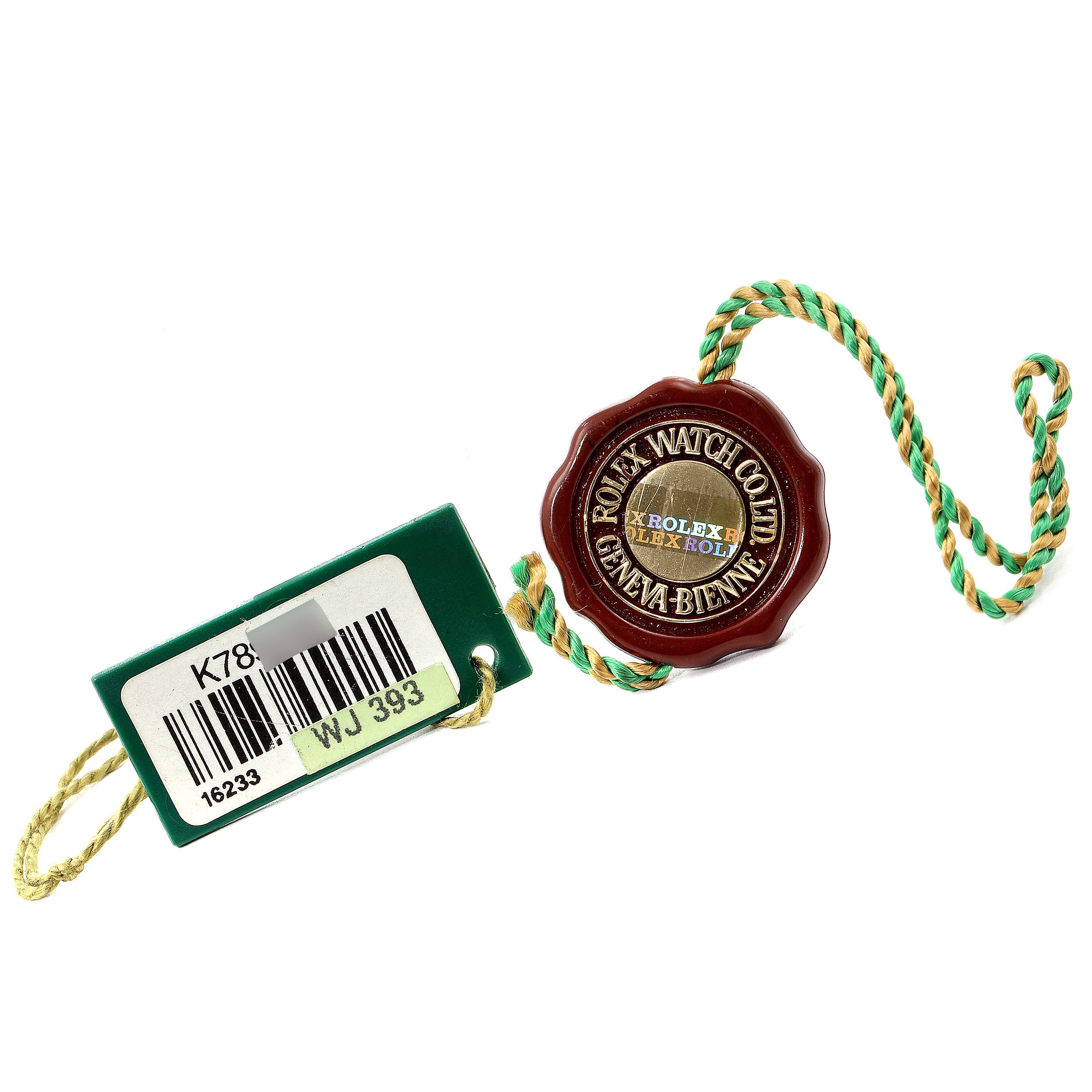 The image shows a green Rolex tag with a barcode and a red seal for a Rolex Datejust 16233 Men's Steel and Gold (two tone) White Dial 16233 Men's Steel and Gold (two tone) White Dial.