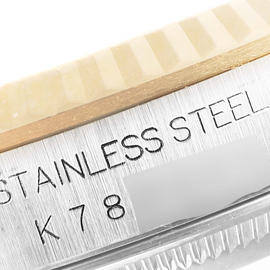 This close-up image shows the bezel and part of the stainless steel case of a Rolex Datejust 16233 Men's Steel and Gold (two tone) White Dial 16233 Men's Steel and Gold (two tone) White Dial watch.