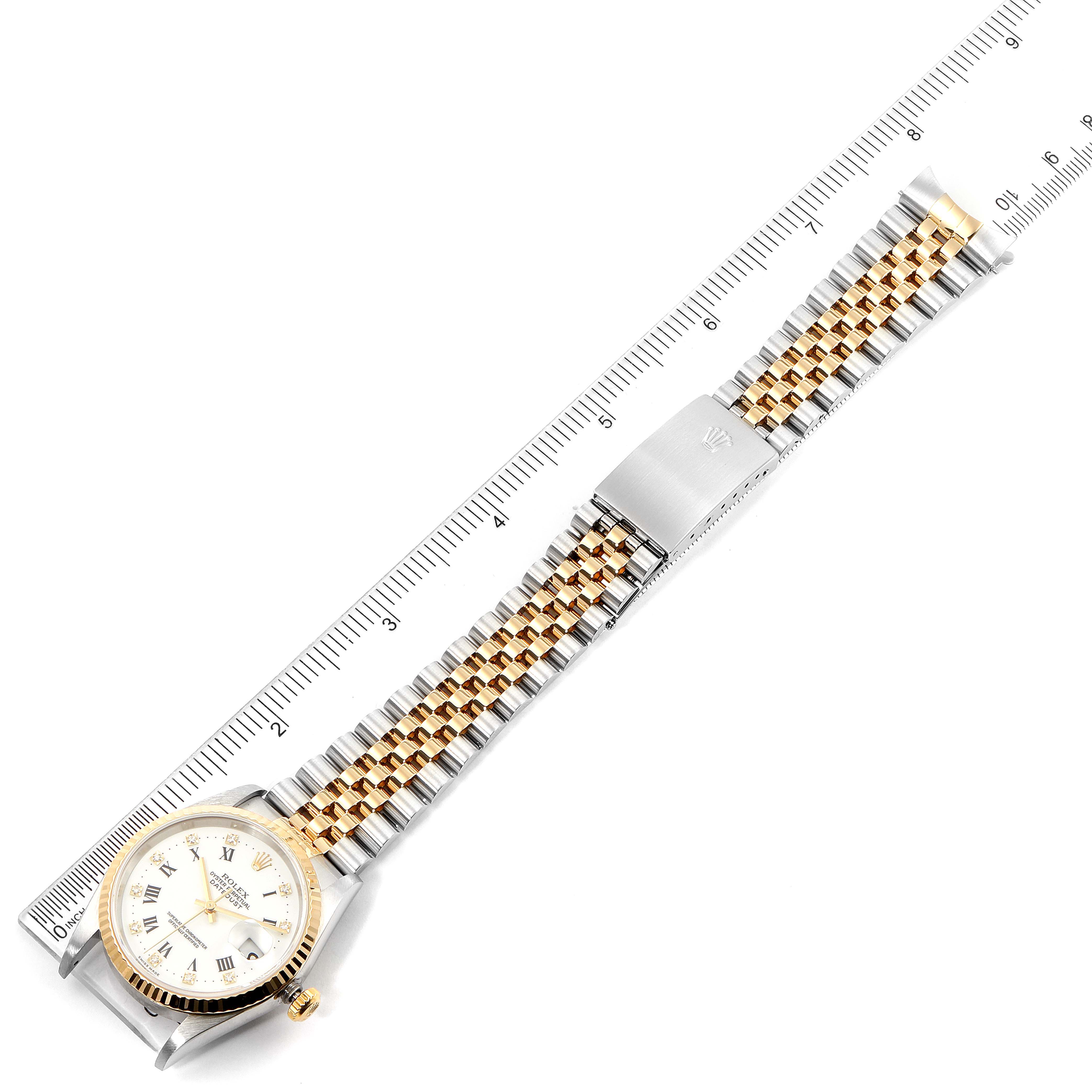 The Rolex Datejust 16233 Men's Steel and Gold (two tone) White Dial 16233 Men's Steel and Gold (two tone) White Dial watch is shown from a top-down angle, displaying the face, bracelet, and clasp, aligned with a ruler.