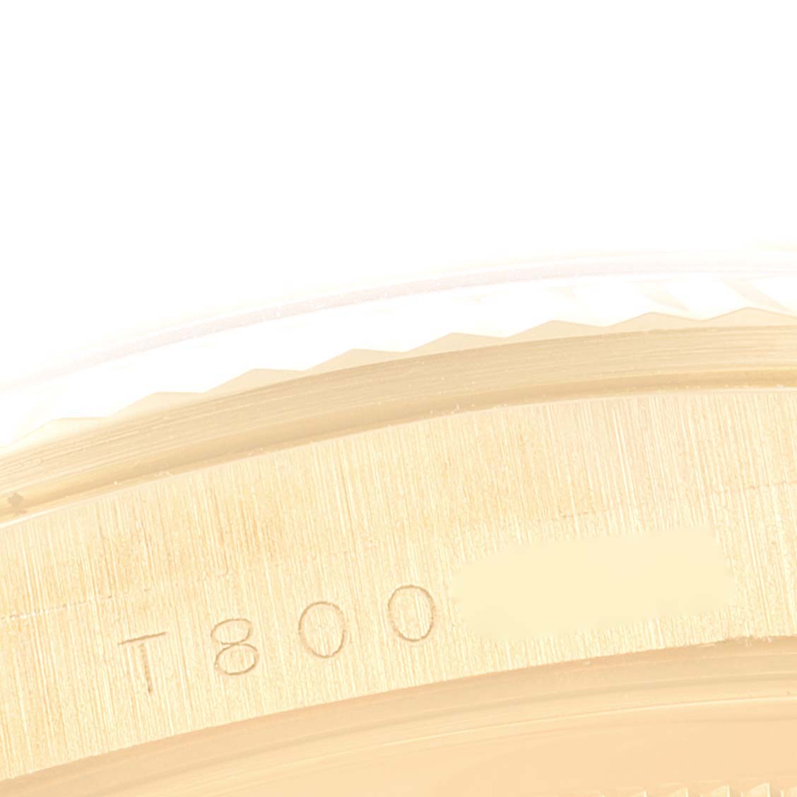 This close-up image shows part of the engraved bezel of a Rolex President 16238 Men
s Yellow Gold Champagne Dial 16238 Men
s Yellow Gold Champagne Dial model watch.