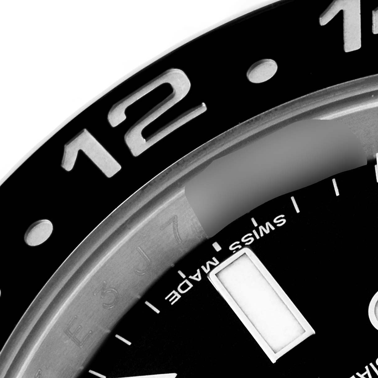 The image shows a close-up of the bezel and dial of a Rolex GMT-Master 116710 Men
s Stainless Steel Black Dial 116710 Men
s Stainless Steel Black Dial watch, focusing on the 12 o
clock marker.